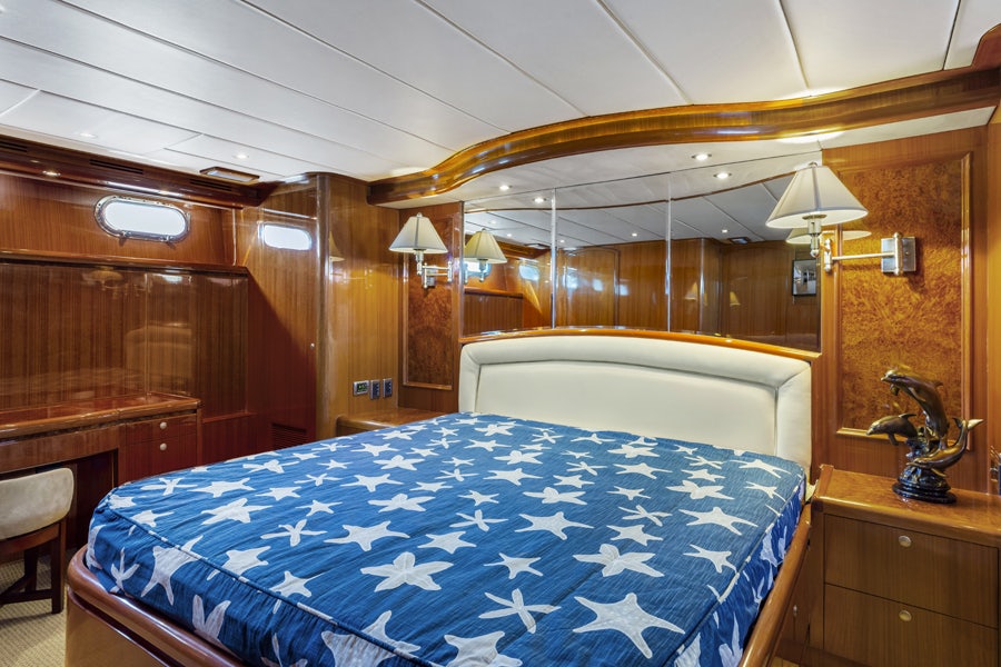a bed with a blue sheet aboard PORK CHOP Yacht for Sale