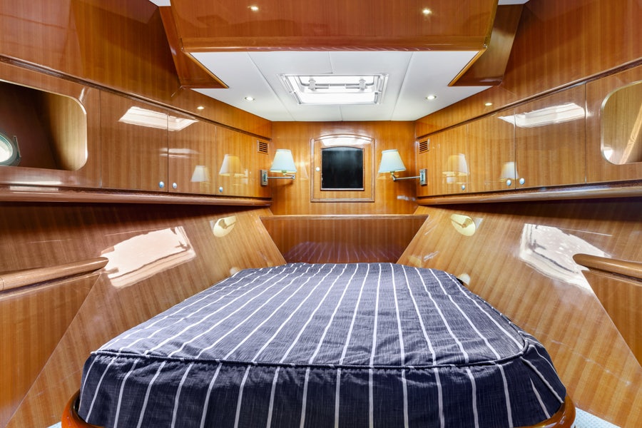 a room with wood walls and a bed aboard PORK CHOP Yacht for Sale