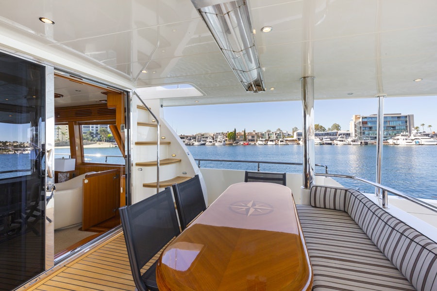 a boat with a table and chairs aboard PORK CHOP Yacht for Sale