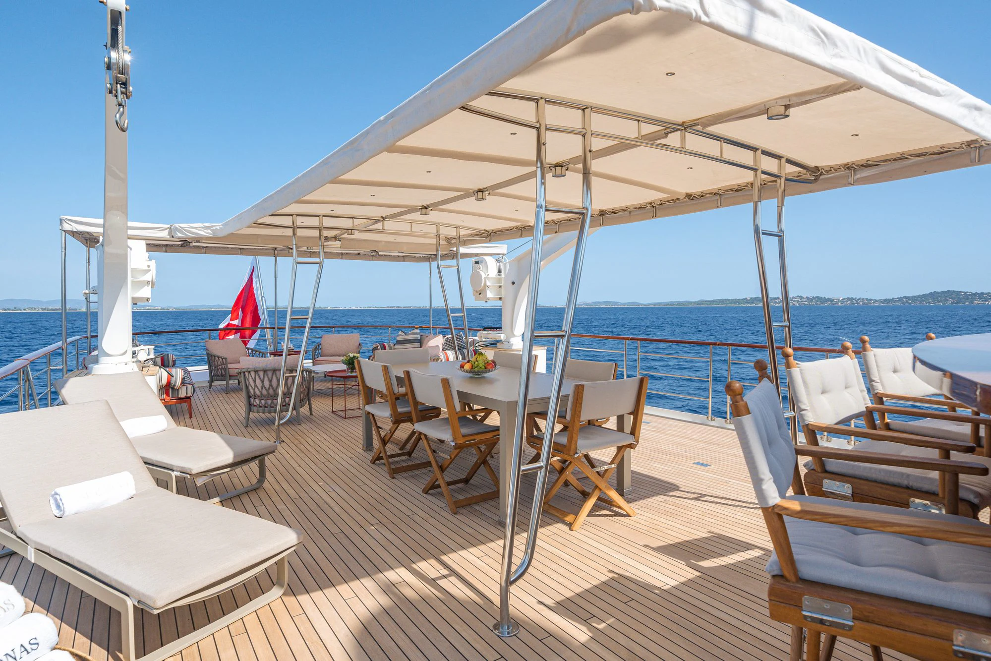 a deck with tables and chairs on it aboard ARIONAS Yacht for Charter