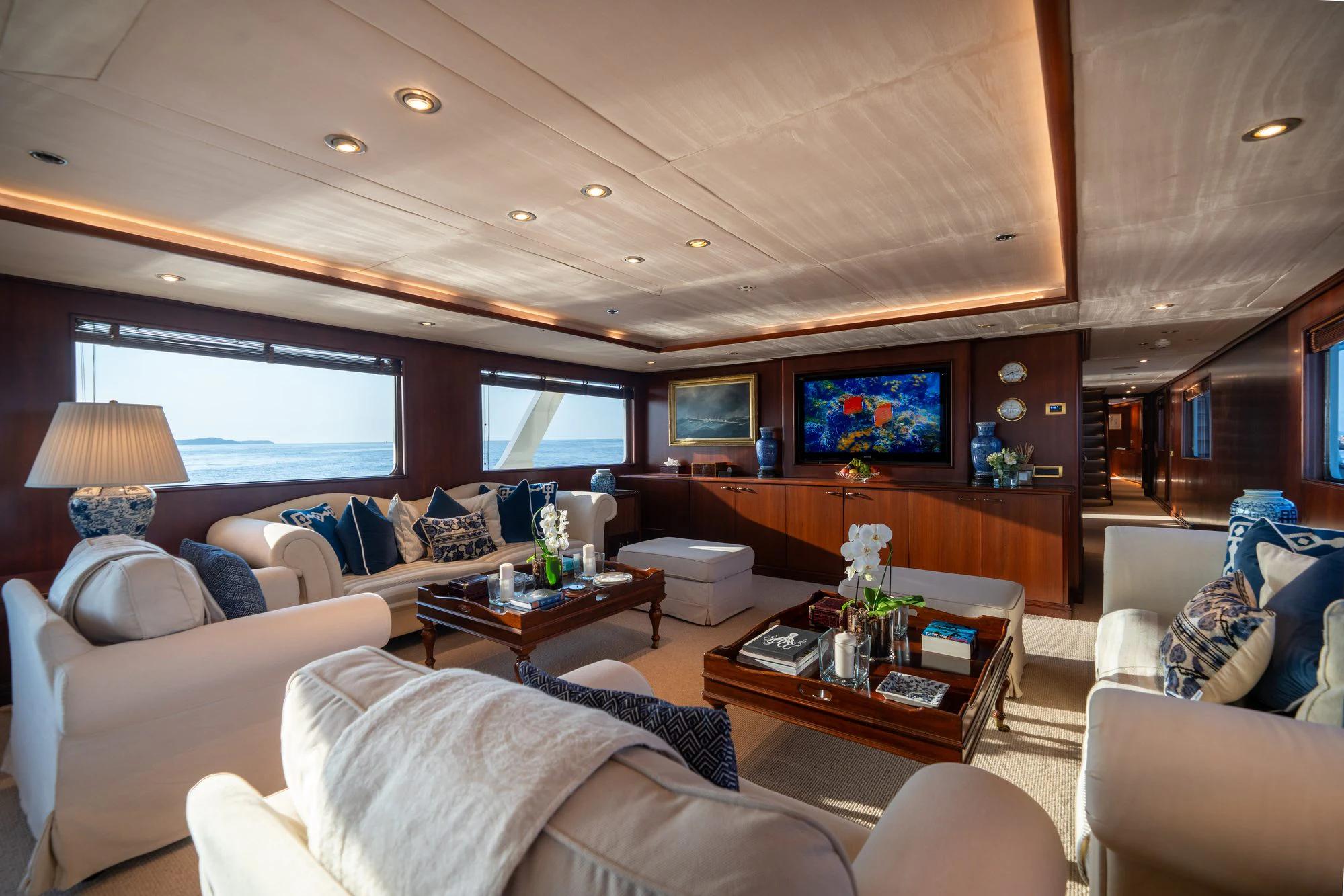 a living room with a large sofa and a tv aboard ARIONAS Yacht for Charter