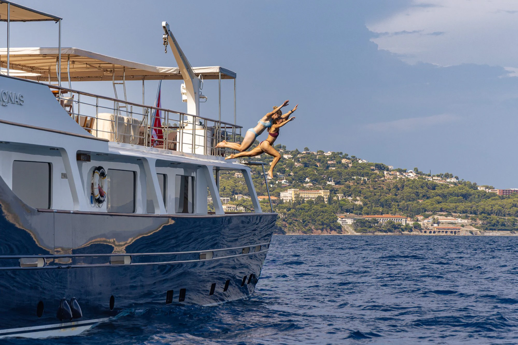 a person jumping off a boat aboard ARIONAS Yacht for Charter