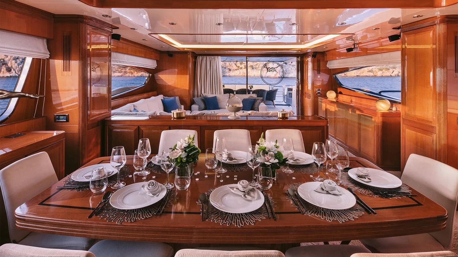 a large dining table with plates and glasses on it aboard ELVI Yacht for Charter