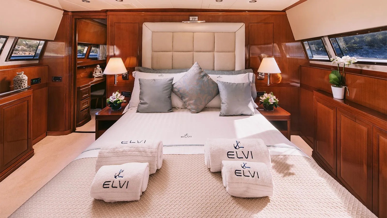 a bed with white sheets and pillows aboard ELVI Yacht for Charter