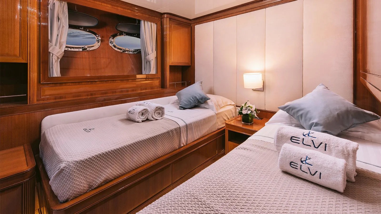 a room with a bed and a mirror aboard ELVI Yacht for Charter