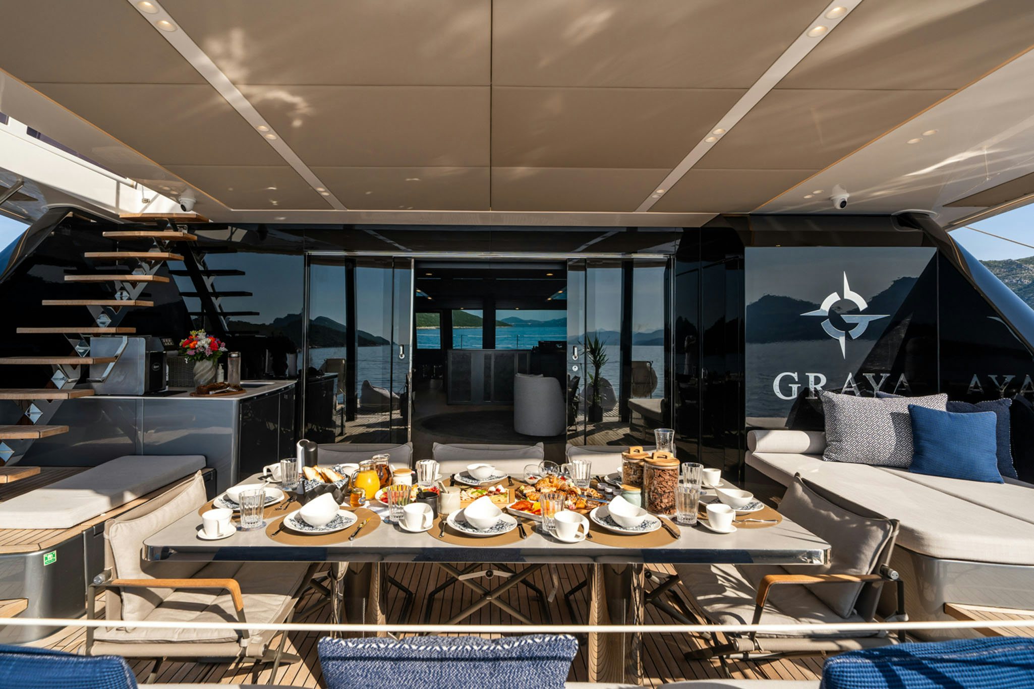 a room with a table and chairs aboard GRAYA Yacht for Charter