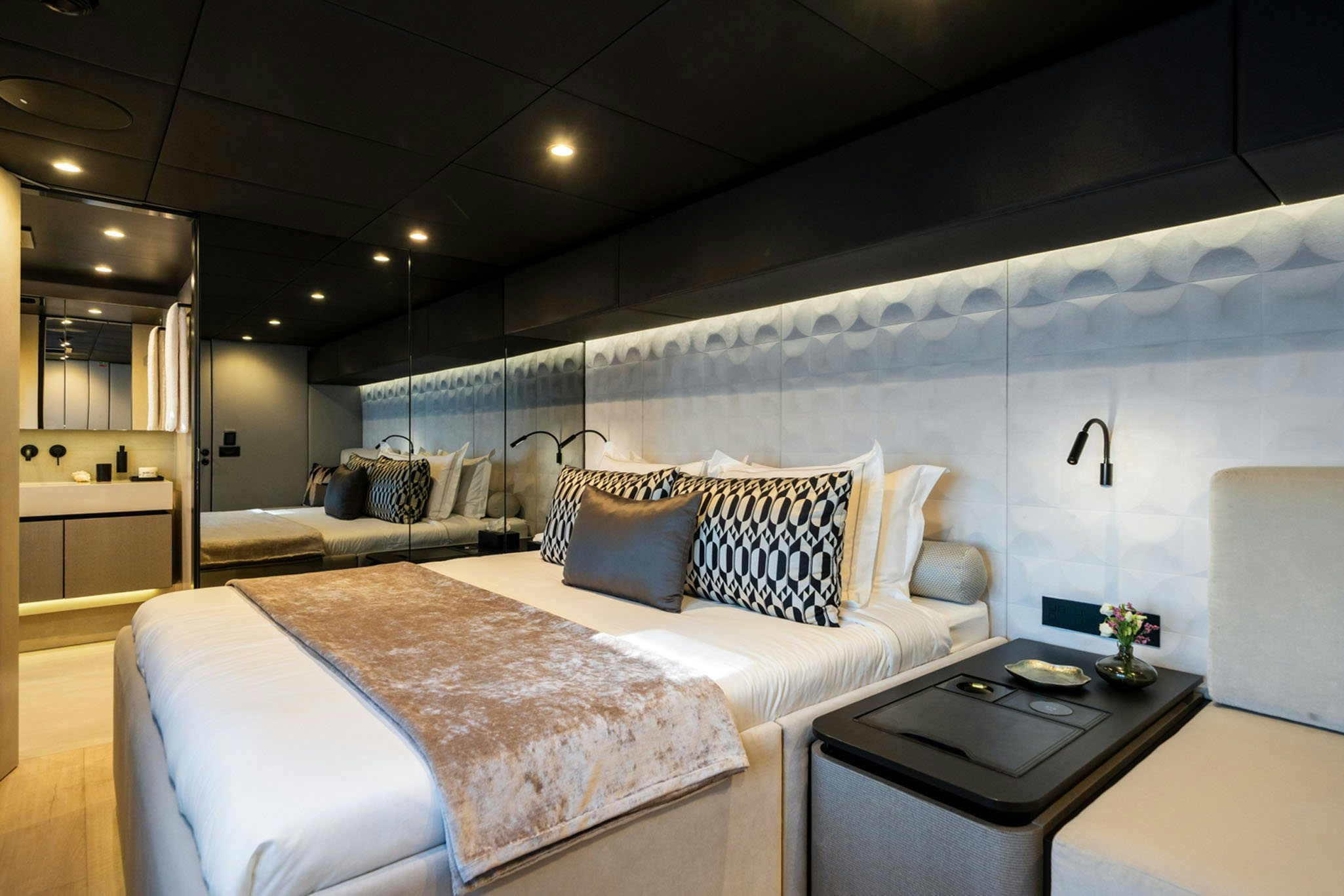 a room with a bed and a couch aboard GRAYA Yacht for Charter