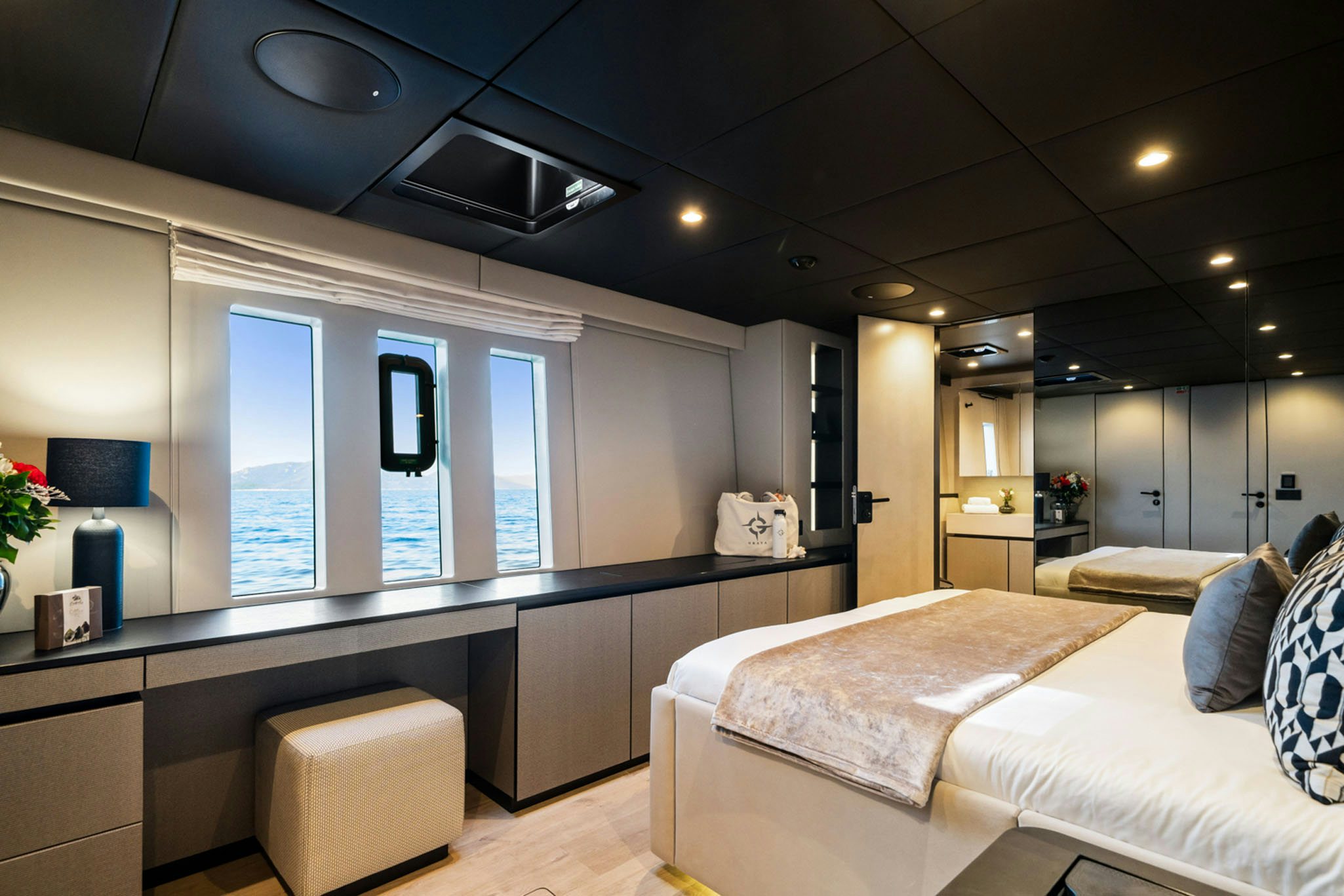 a room with a bed and a desk aboard GRAYA Yacht for Charter