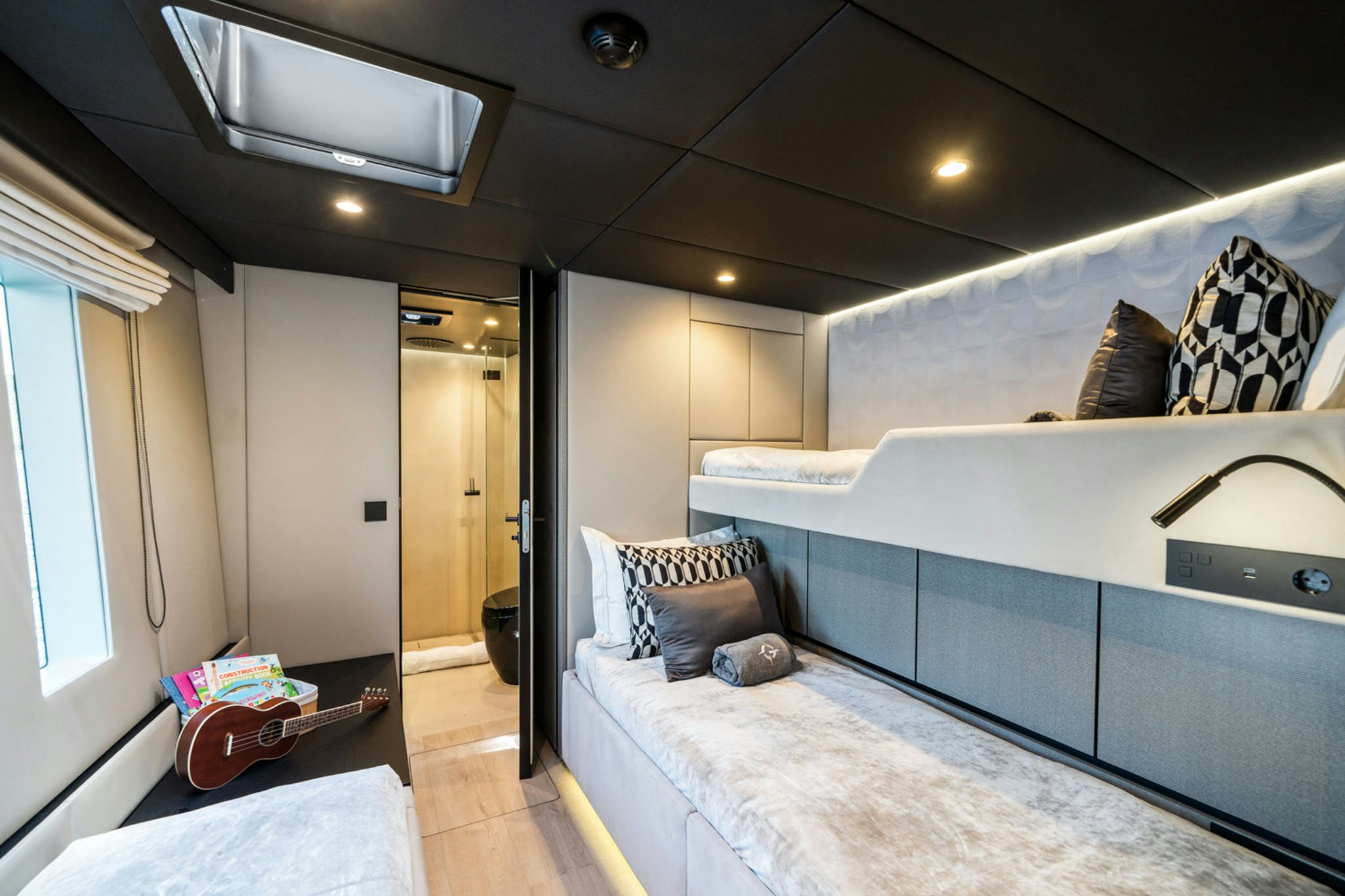 a bedroom with a bed and a mirror aboard GRAYA Yacht for Charter