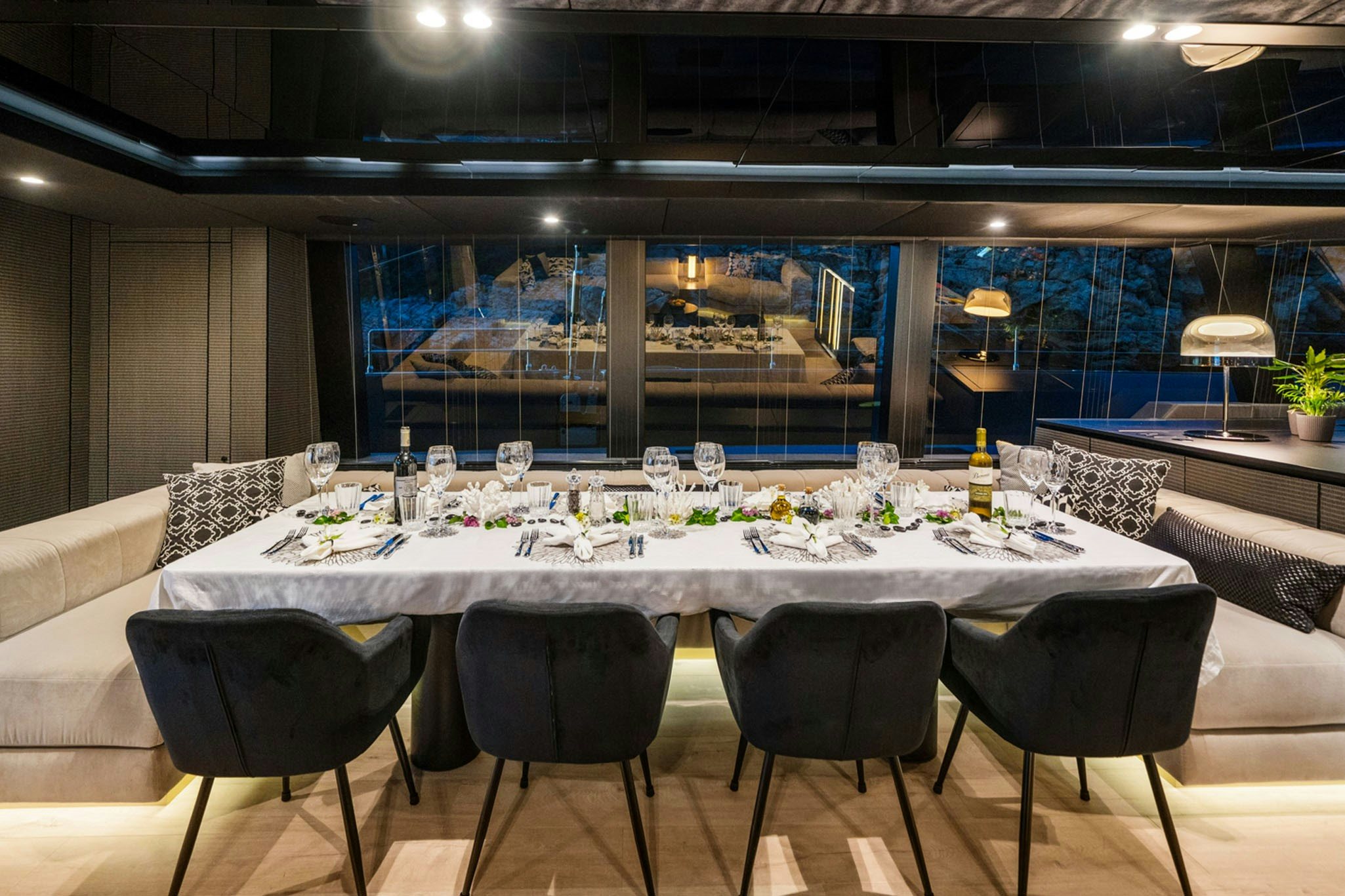 a table set for a dinner party aboard GRAYA Yacht for Charter