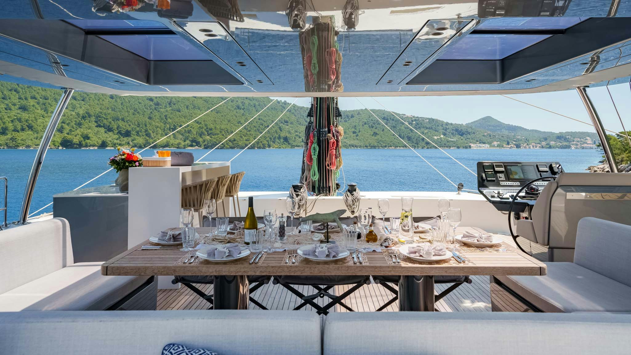 a table with food and drinks on it aboard GRAYA Yacht for Charter