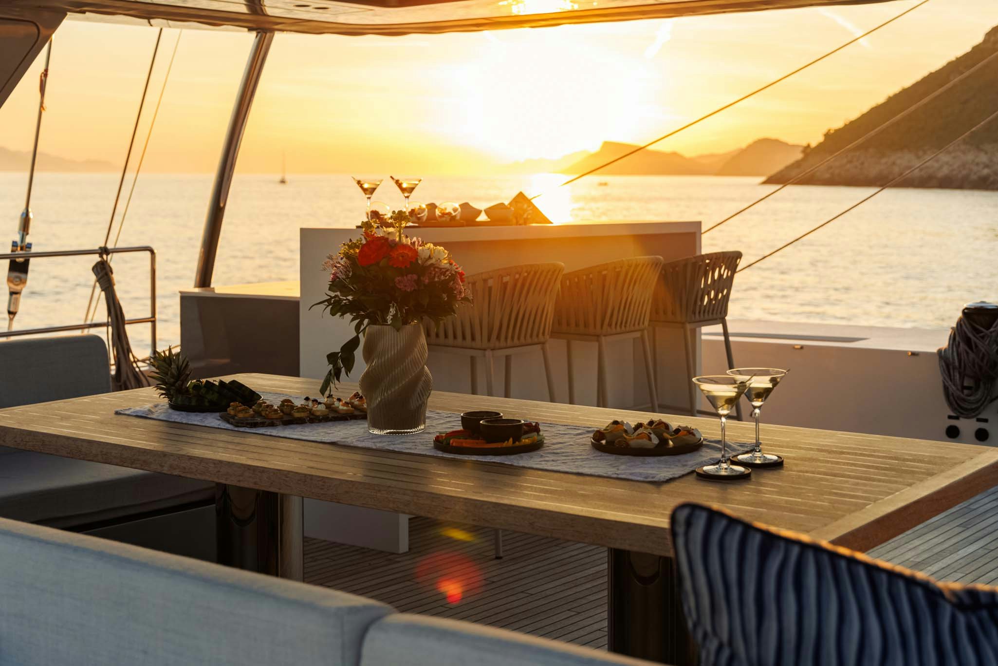 a table with food and glasses on it aboard GRAYA Yacht for Charter