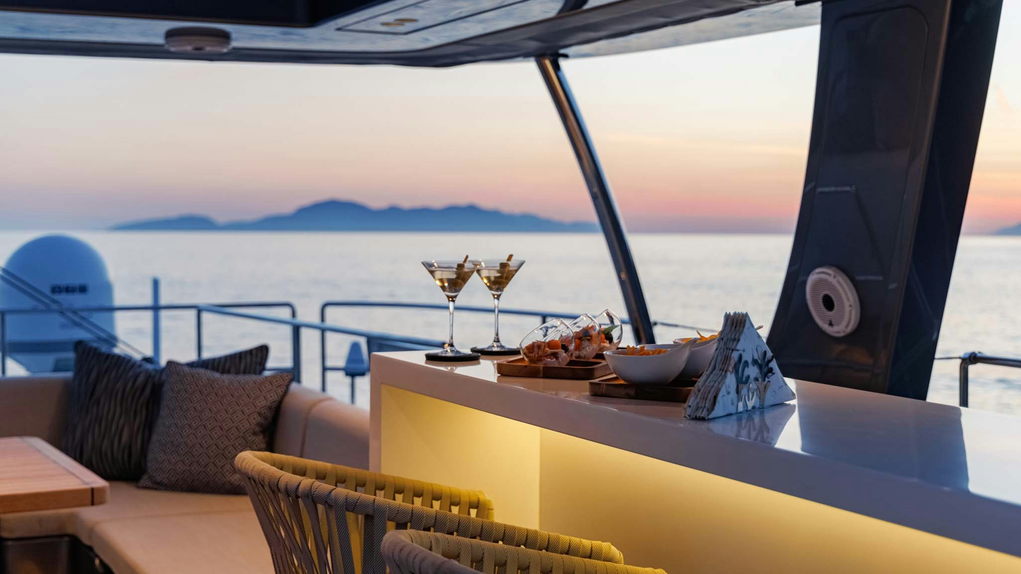 a table with wine glasses on it aboard GRAYA Yacht for Charter