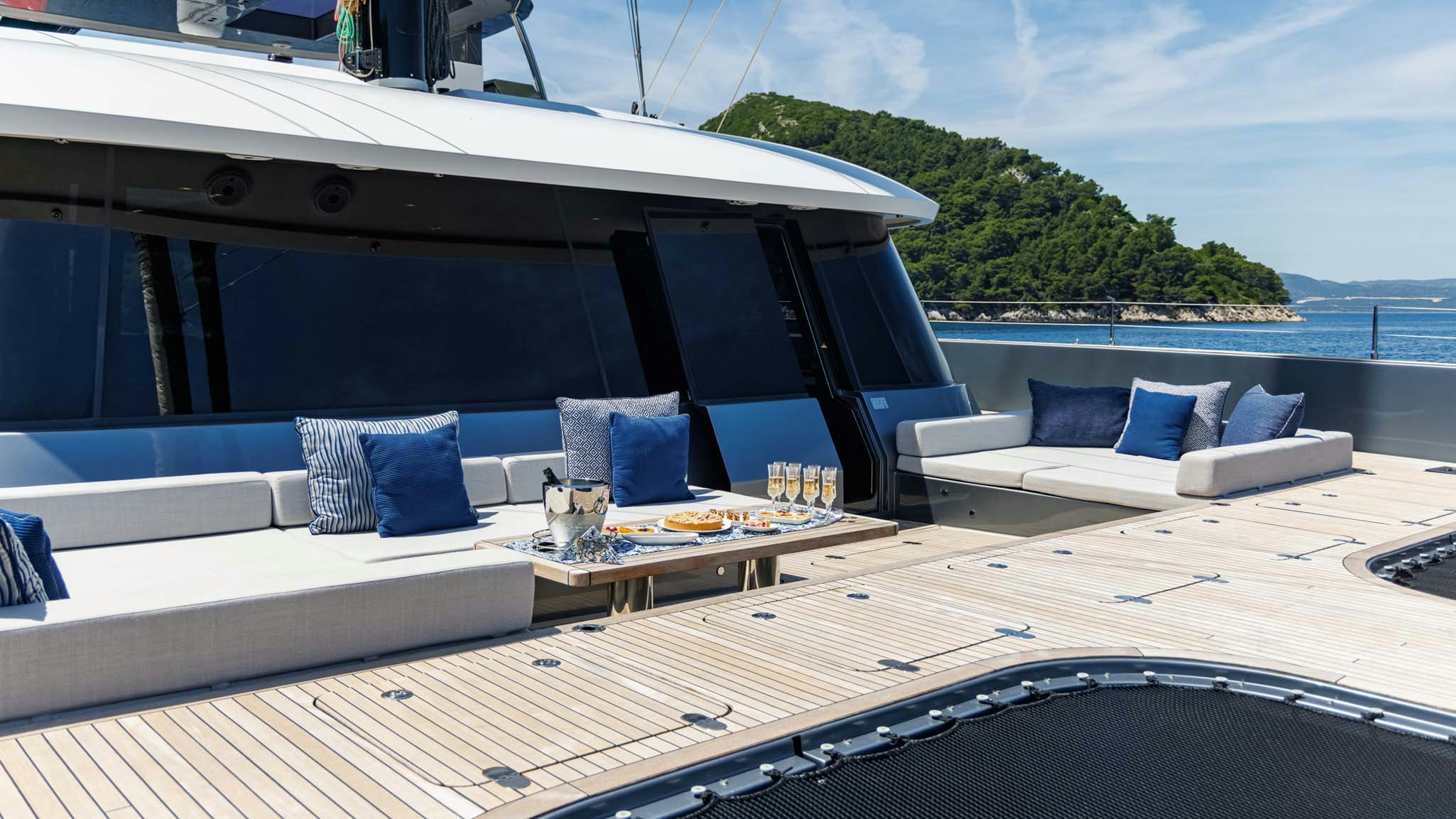 a deck with a large body of water and a couch aboard GRAYA Yacht for Charter