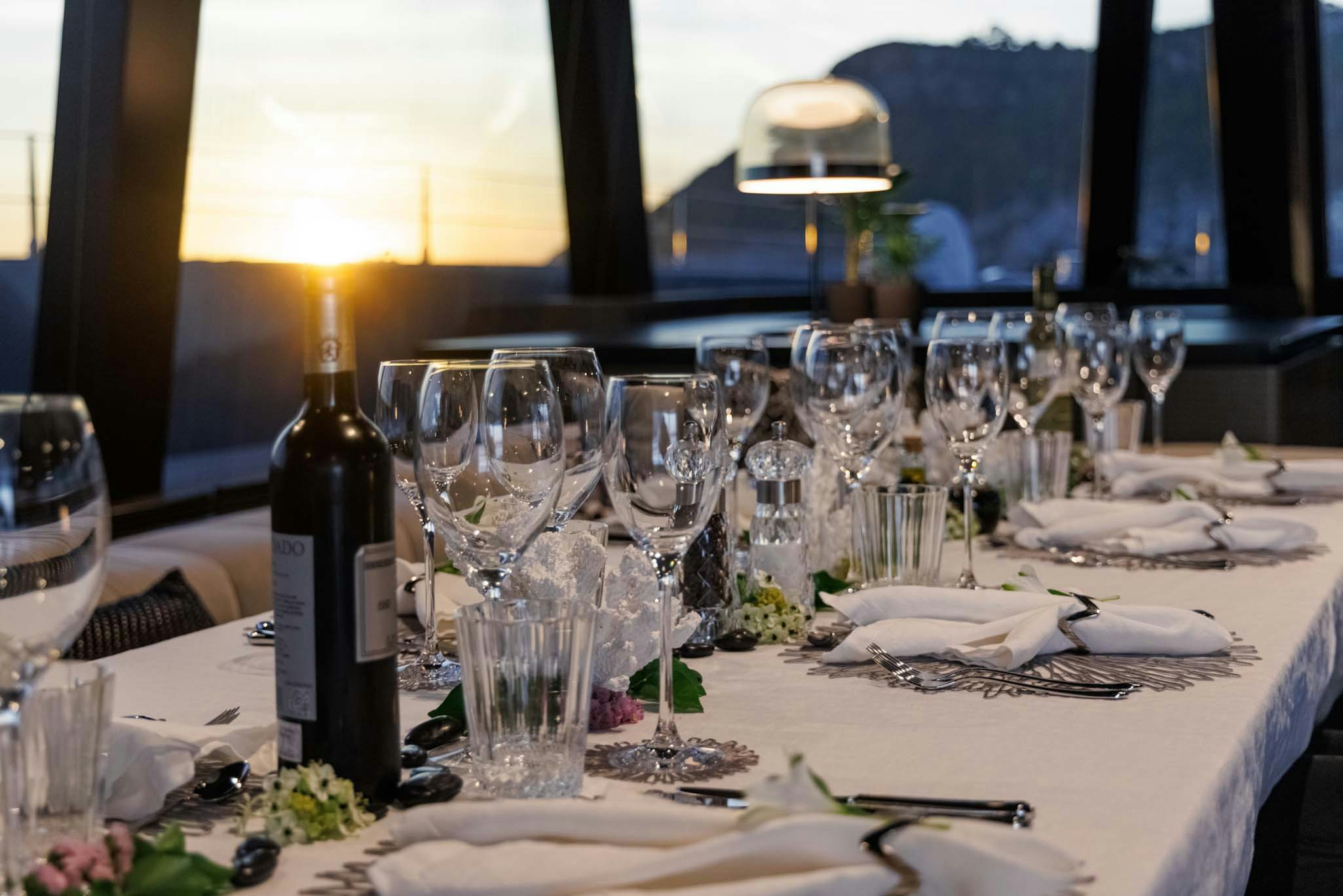 a table with wine glasses and bottles aboard GRAYA Yacht for Charter