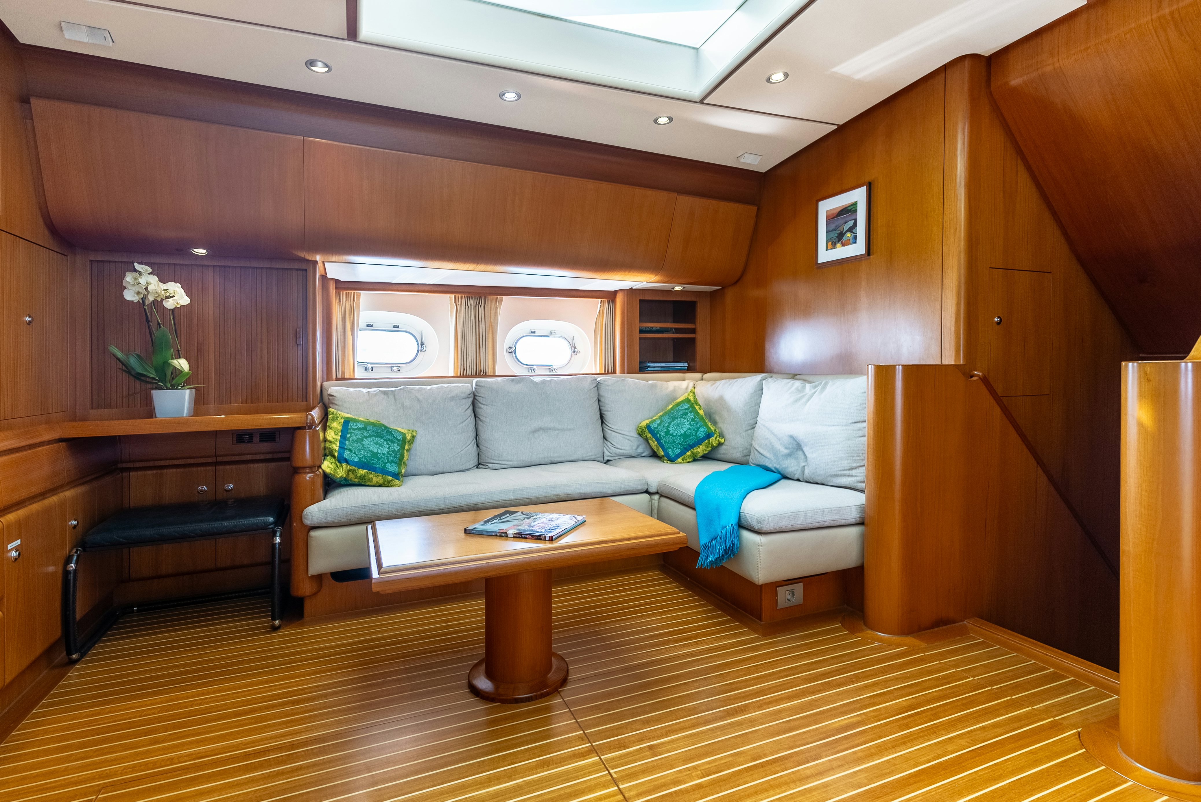 a living room with a couch and a table aboard LA JOIE DE MER Yacht for Sale