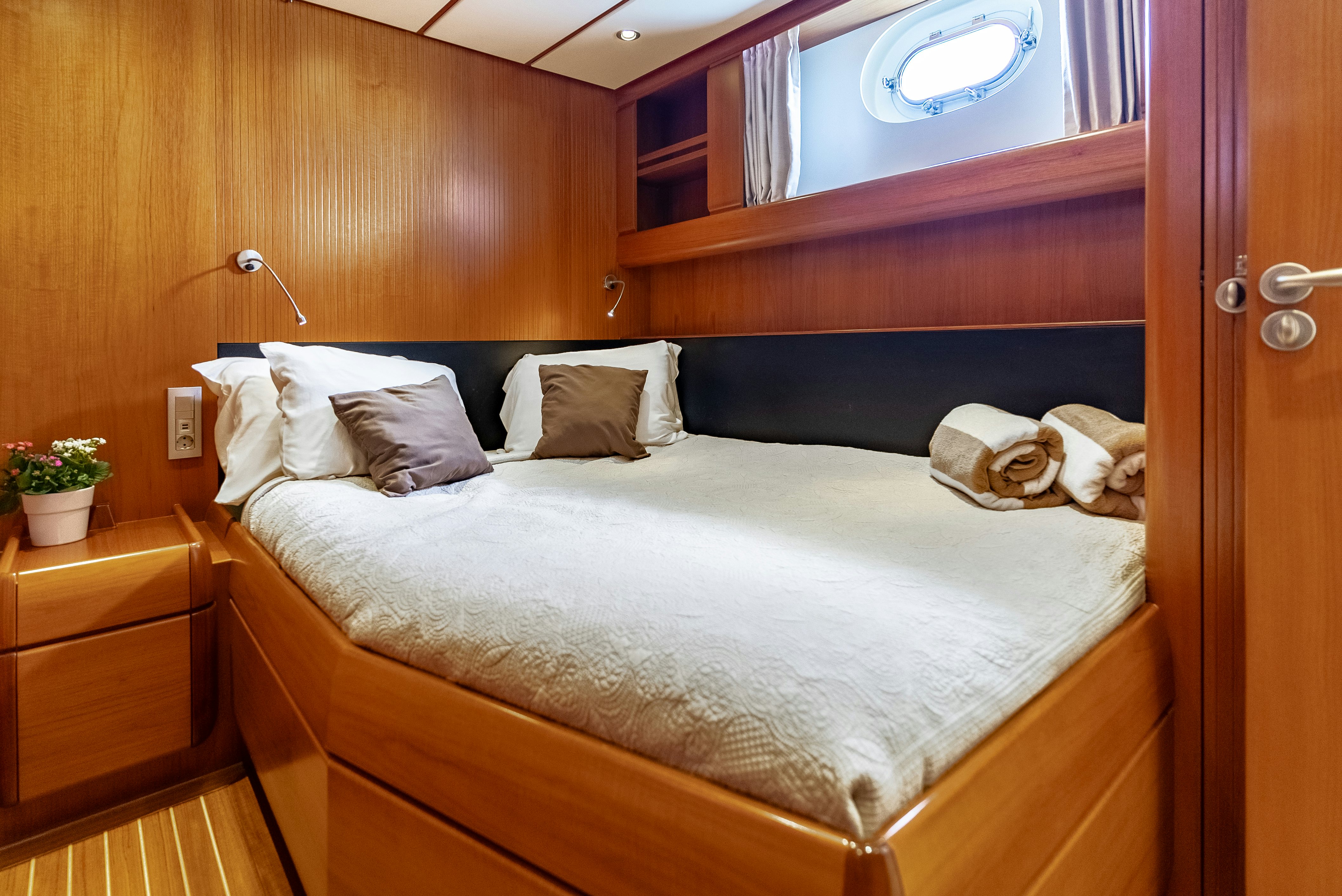 a bed with white sheets aboard LA JOIE DE MER Yacht for Sale
