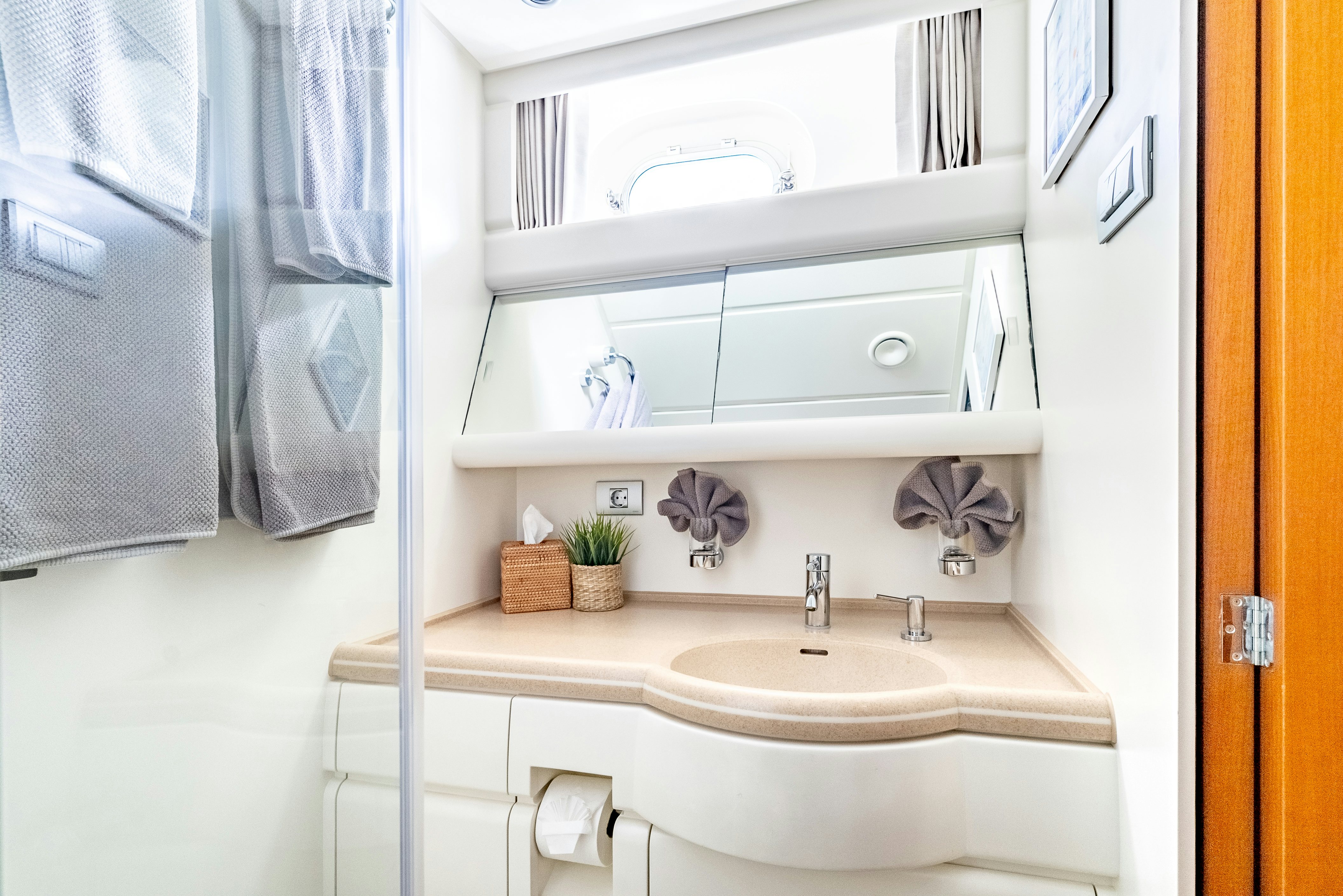 a bathroom with a sink and cabinets aboard LA JOIE DE MER Yacht for Sale