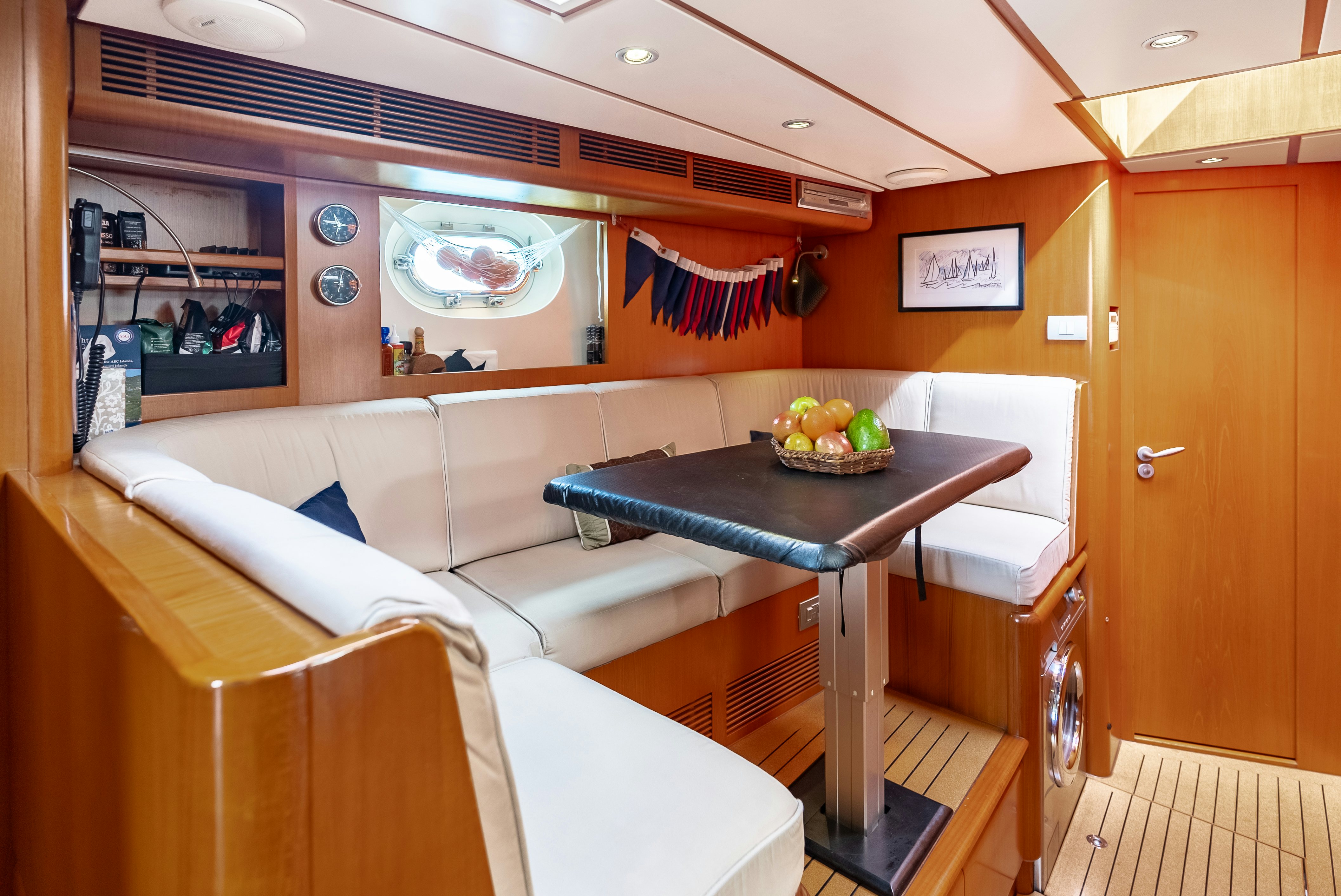 a room with a table and chairs aboard LA JOIE DE MER Yacht for Sale