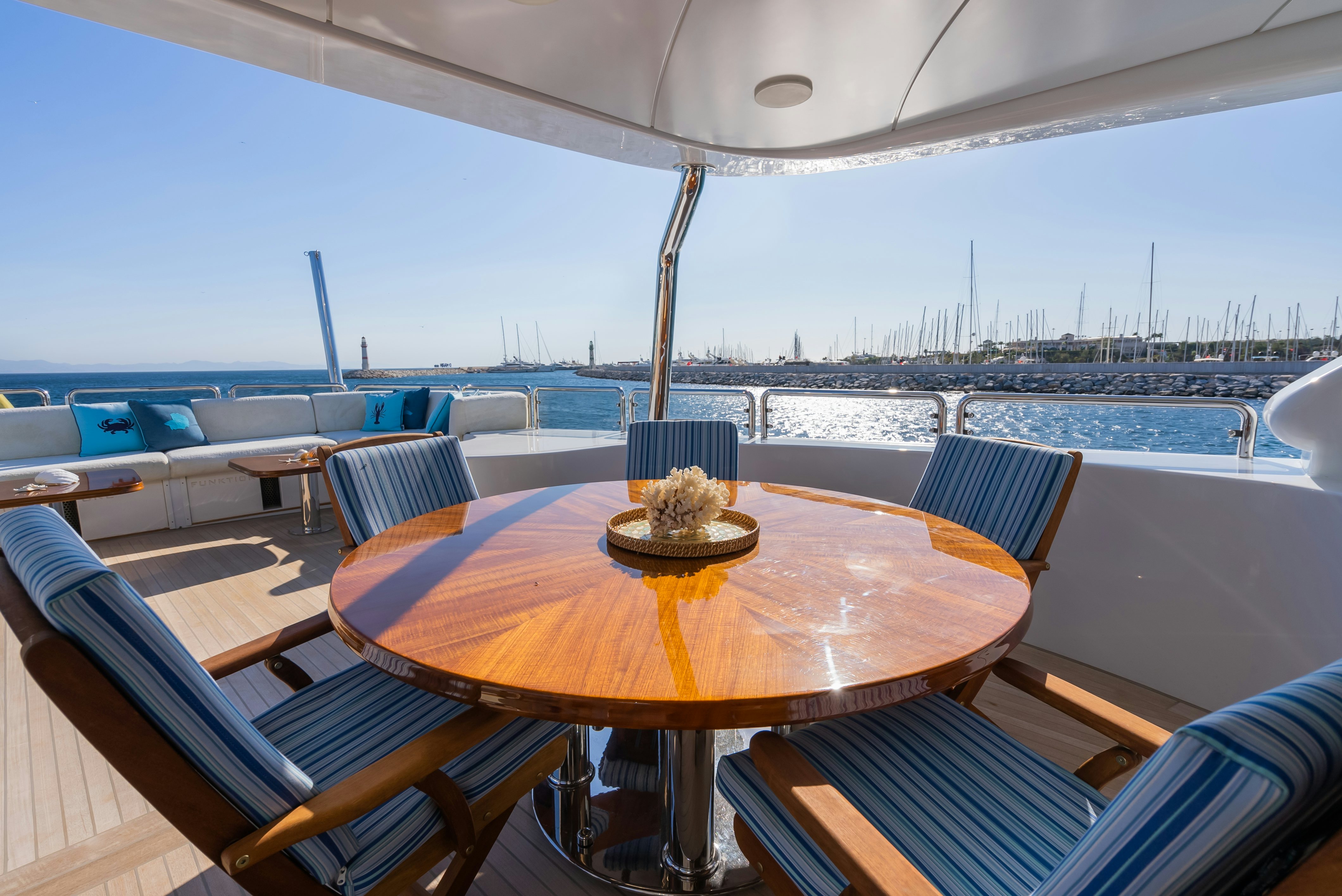 a table with a plate of food on it aboard STELLA FIERA Yacht for Sale