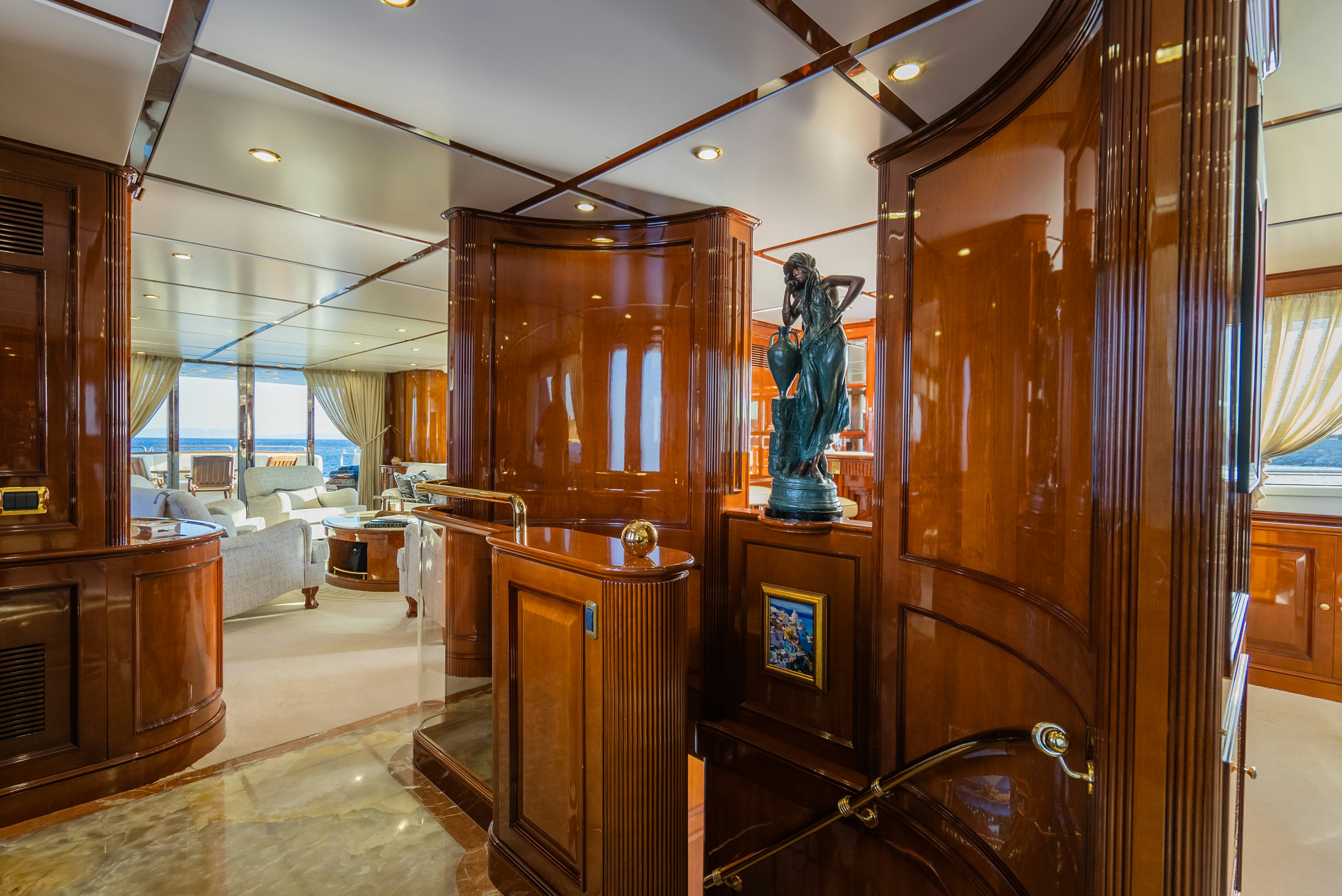 a large room with a large wood cabinet and a statue aboard STELLA FIERA Yacht for Sale