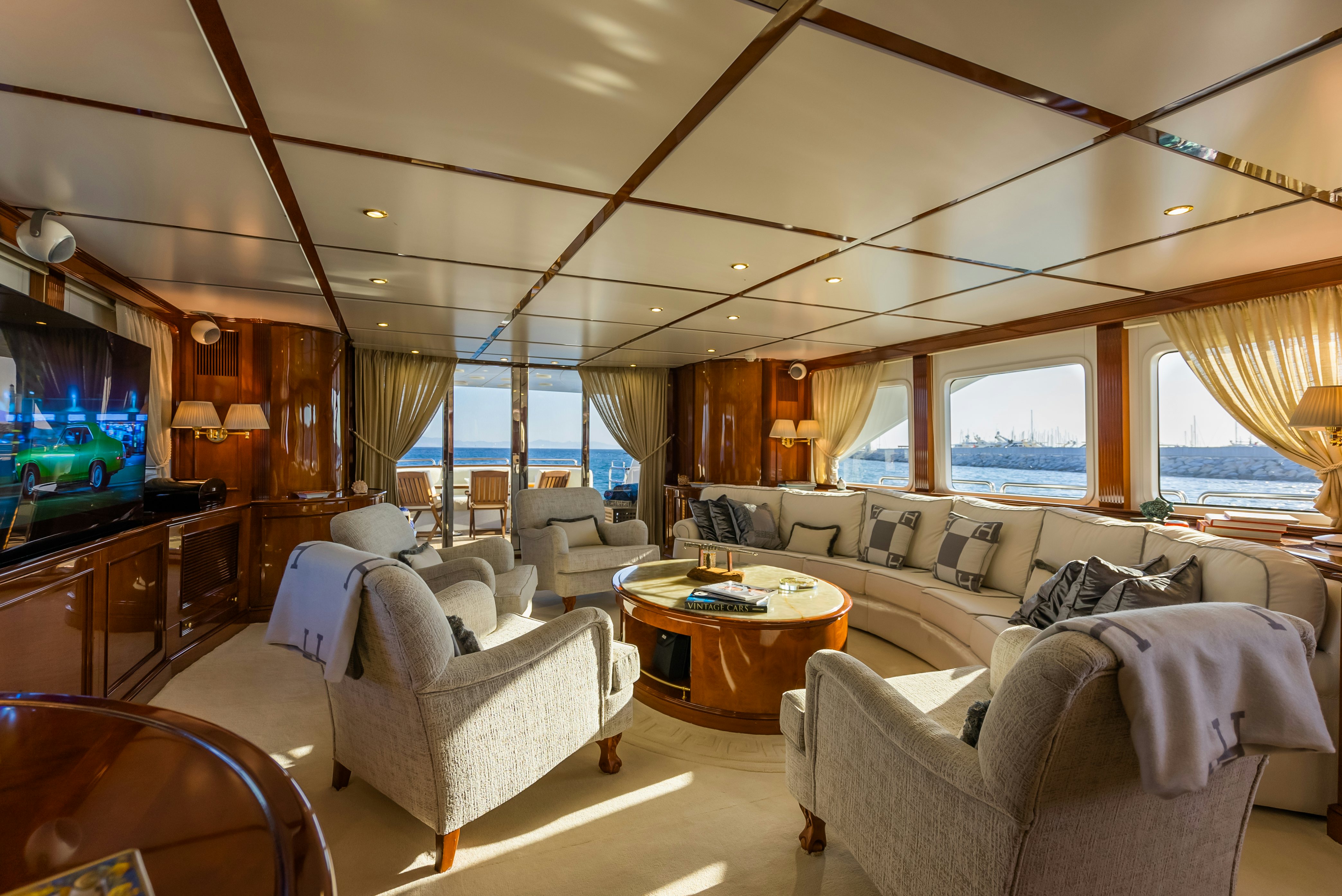 a living room with a large screen aboard STELLA FIERA Yacht for Sale