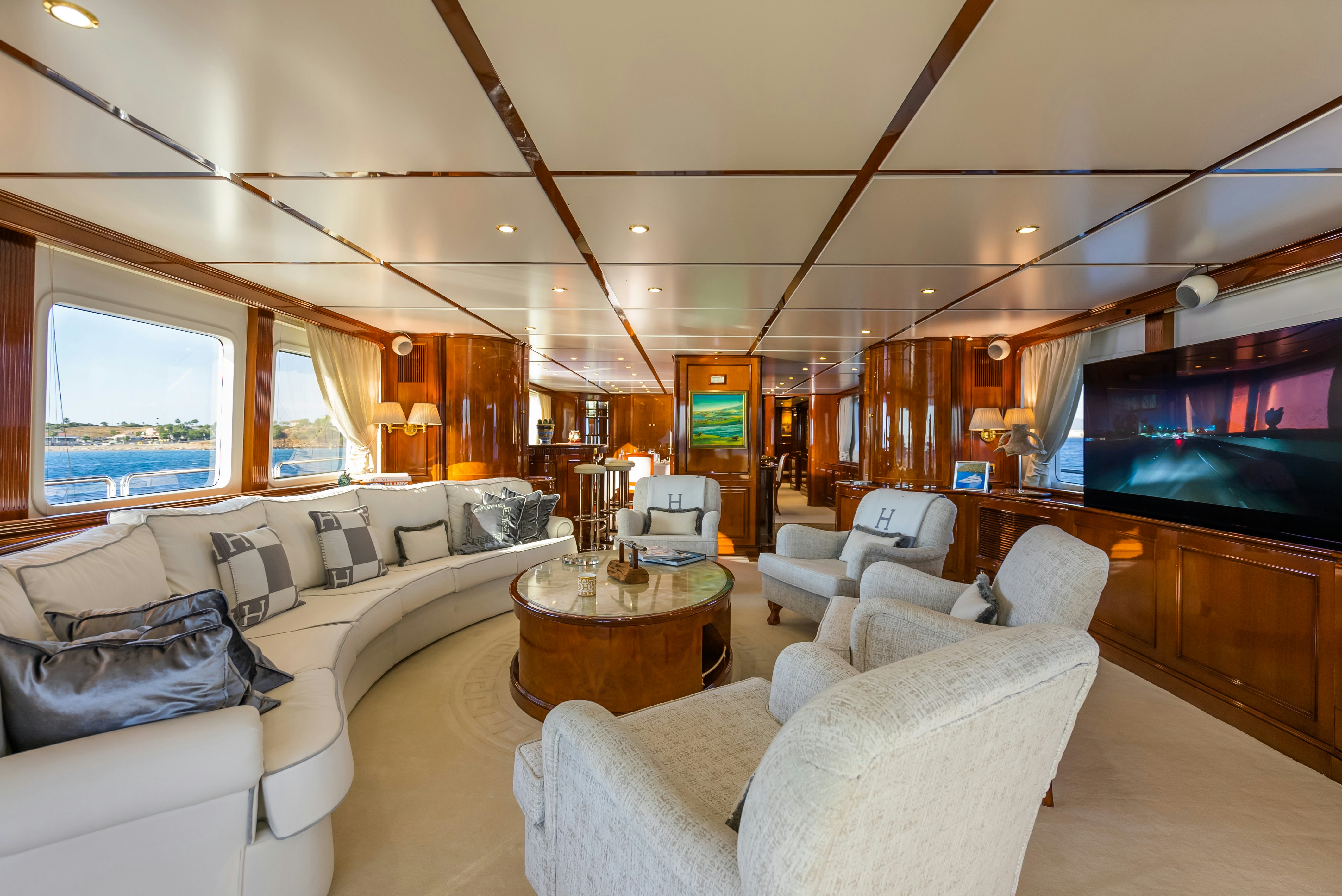 a living room with a large screen aboard STELLA FIERA Yacht for Sale