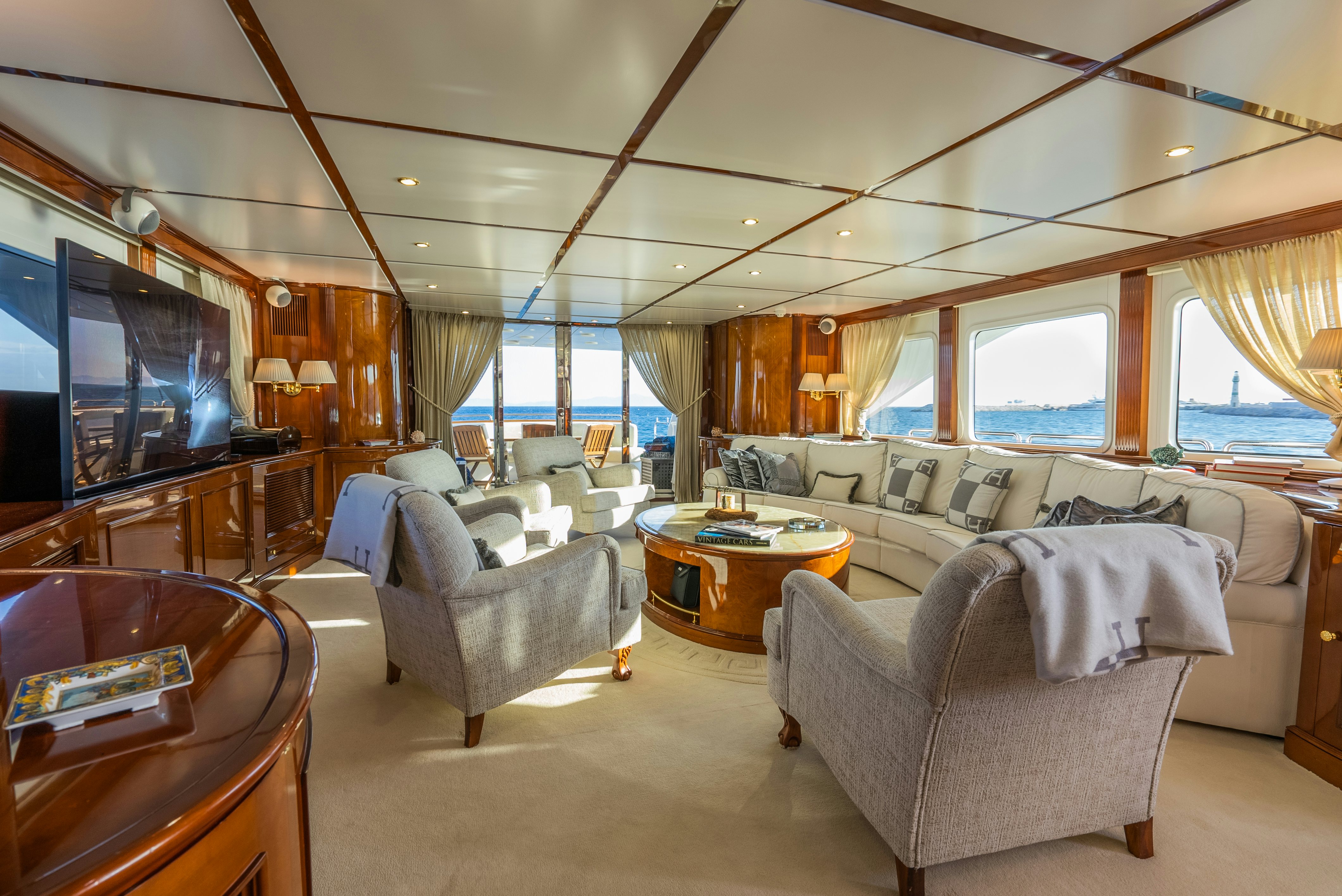 a living room with a large television aboard STELLA FIERA Yacht for Sale
