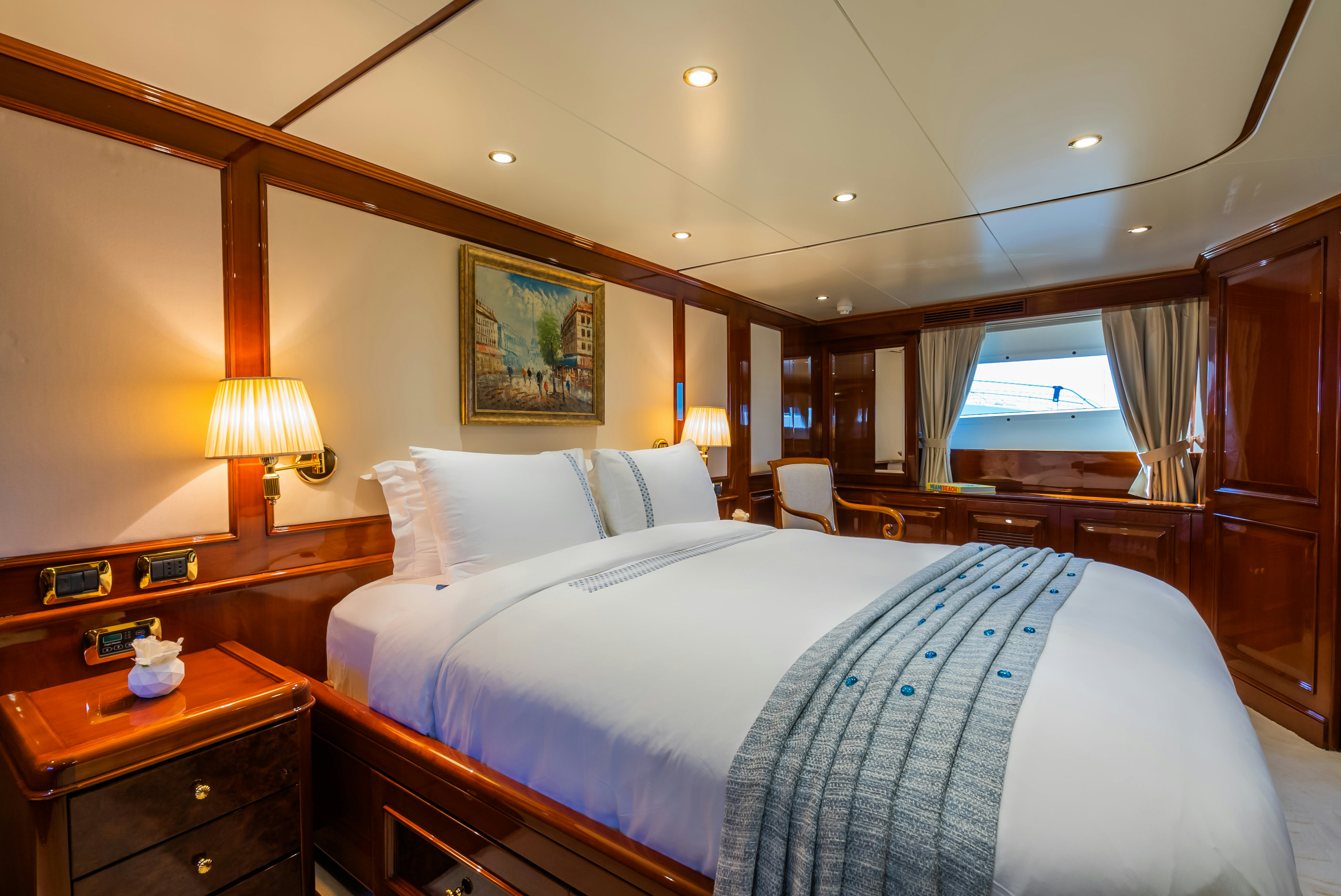 a bed with a blue sheet aboard STELLA FIERA Yacht for Sale