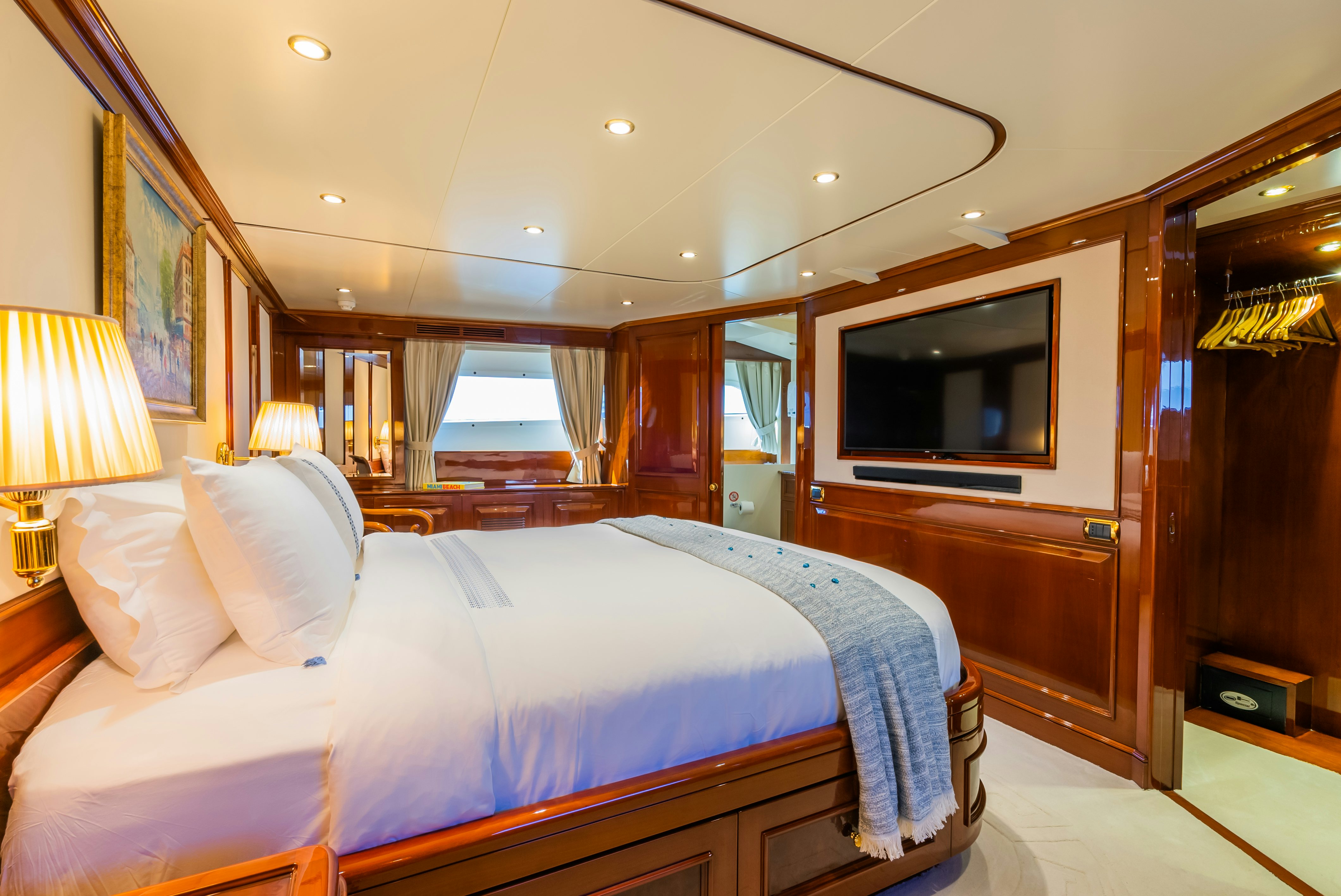 a bedroom with a bed and a television aboard STELLA FIERA Yacht for Sale