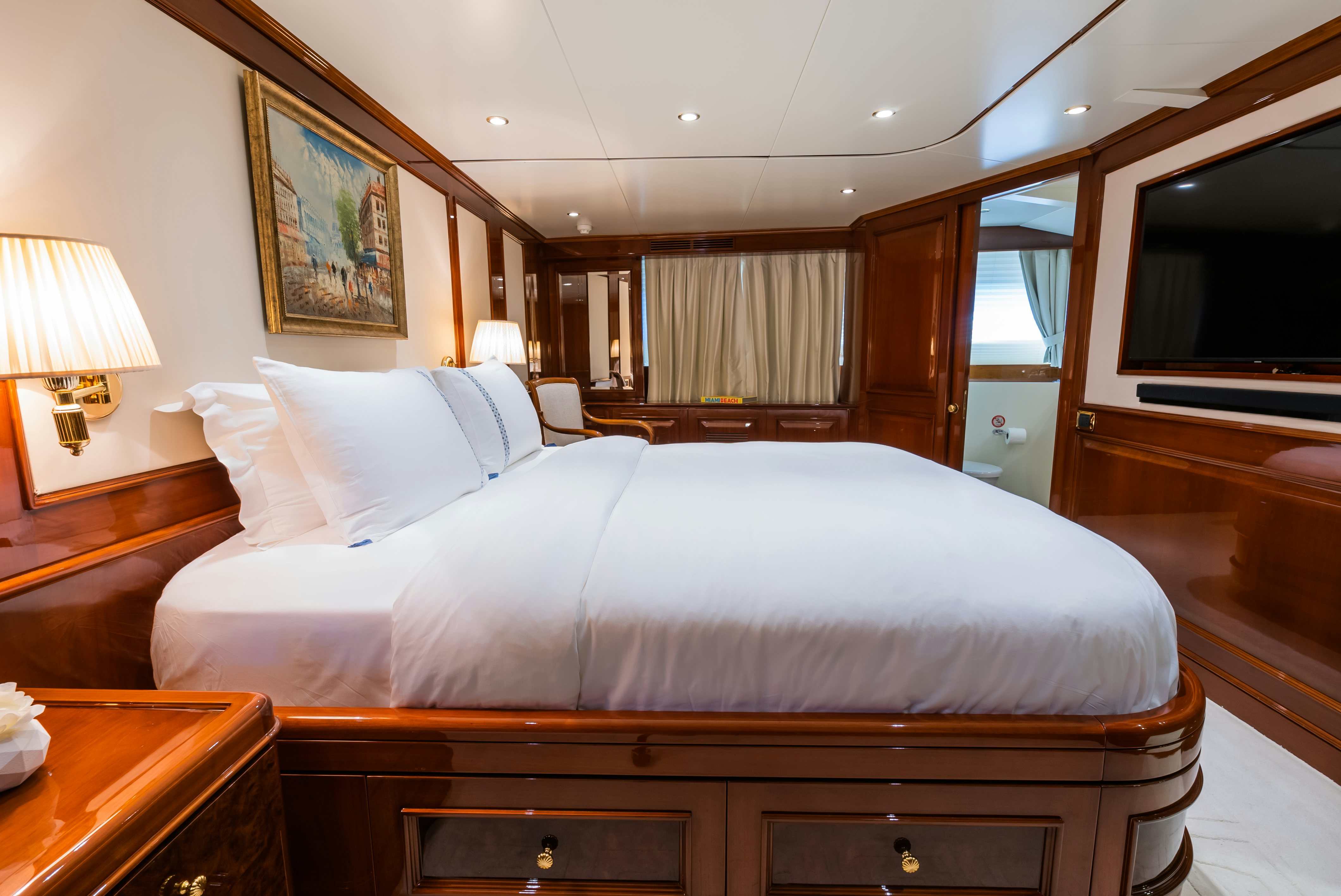 a hotel room with a bed and a television aboard STELLA FIERA Yacht for Sale