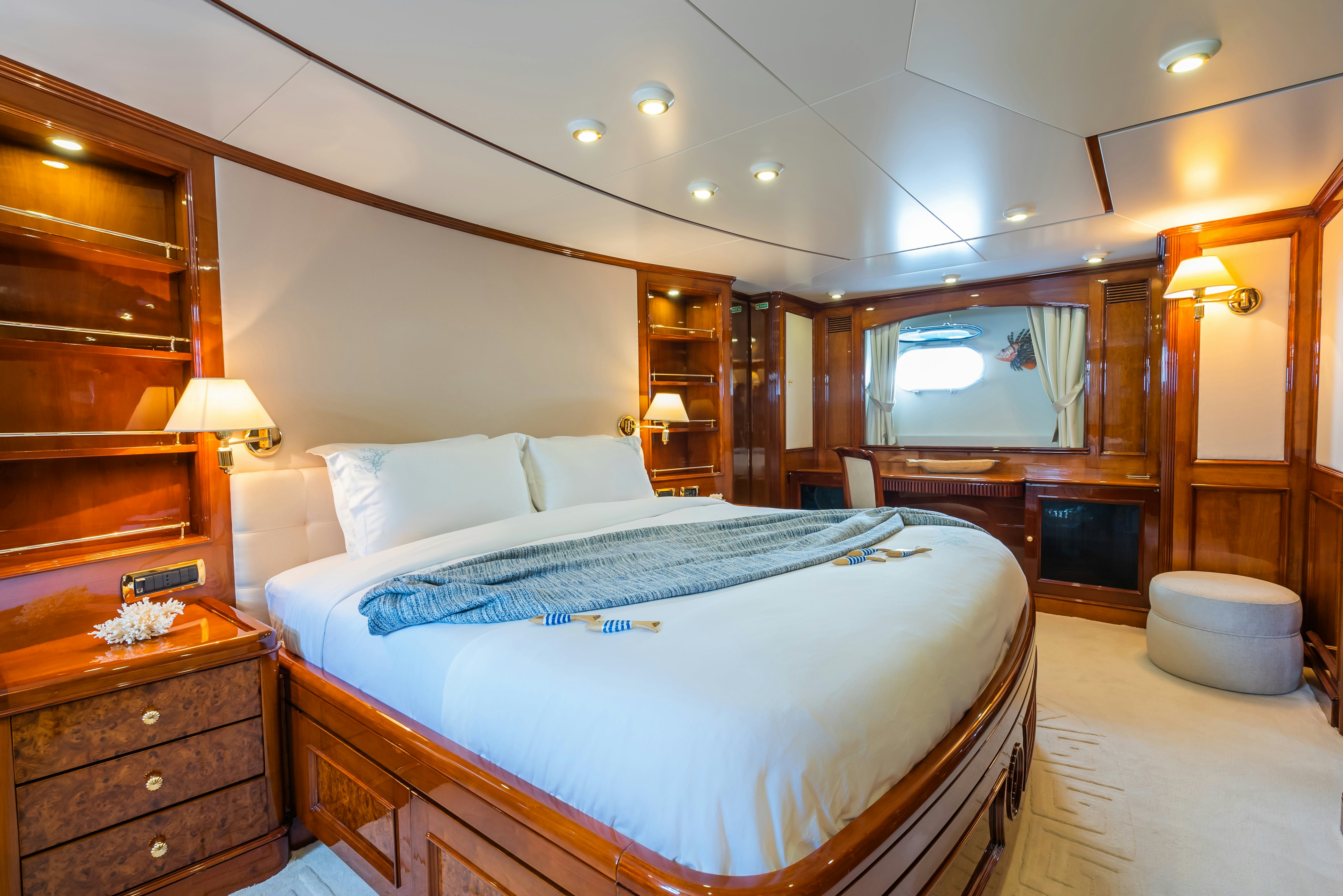 a bedroom with a bed and a mirror aboard STELLA FIERA Yacht for Sale