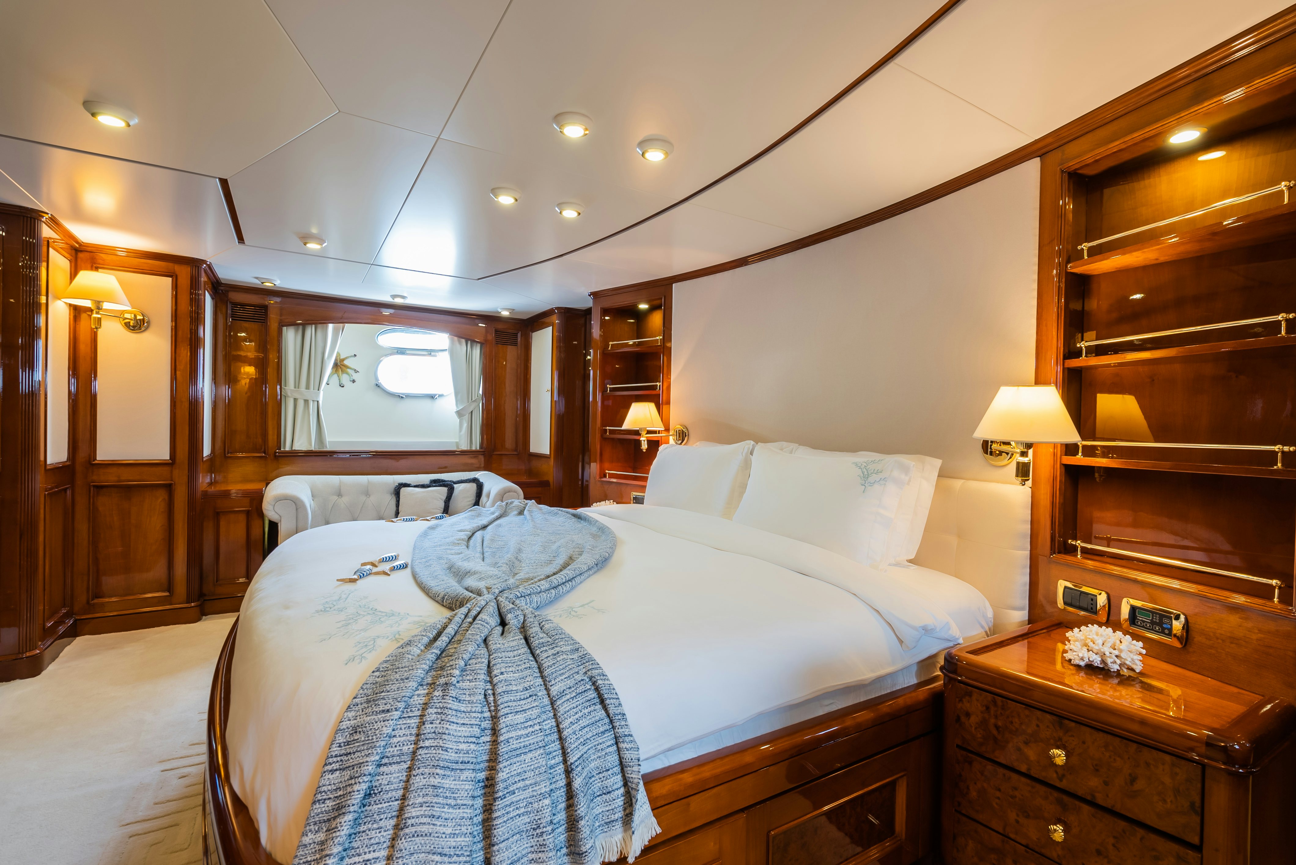 a bed with a blue blanket aboard STELLA FIERA Yacht for Sale