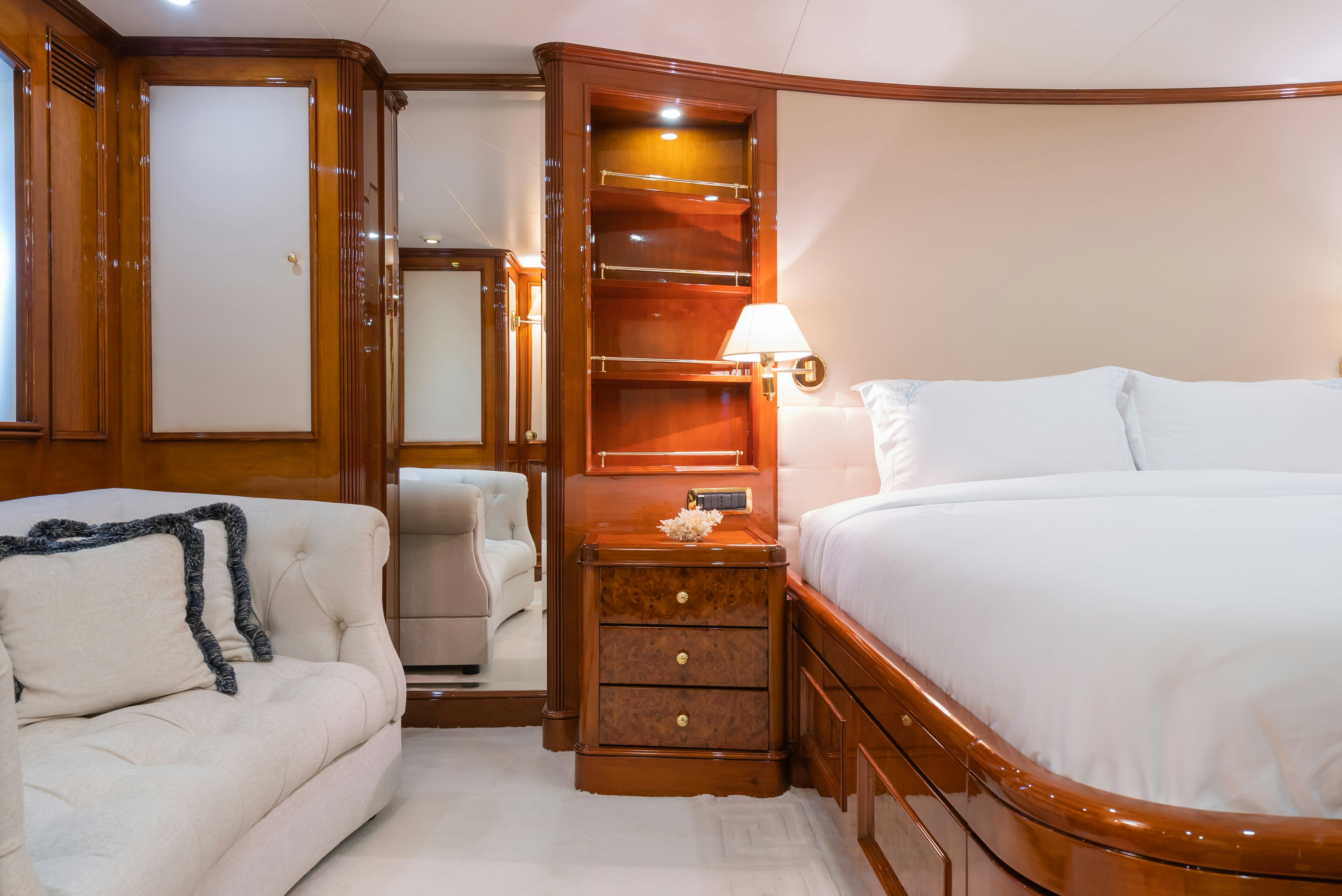 a bedroom with a bed and a chair aboard STELLA FIERA Yacht for Sale