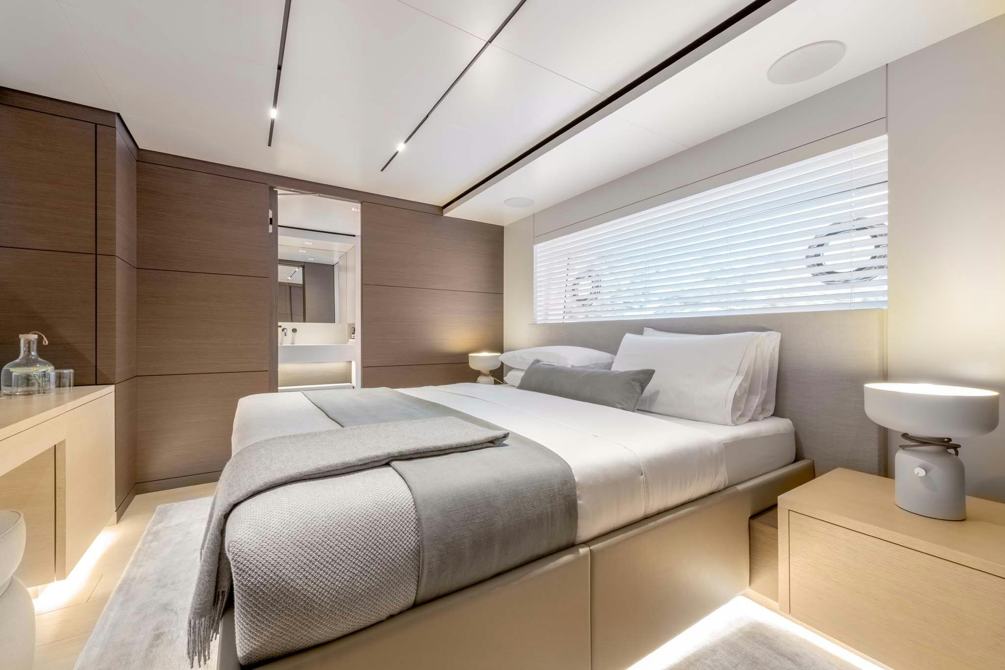 a bedroom with a bed and a desk aboard PALOMA Yacht for Charter