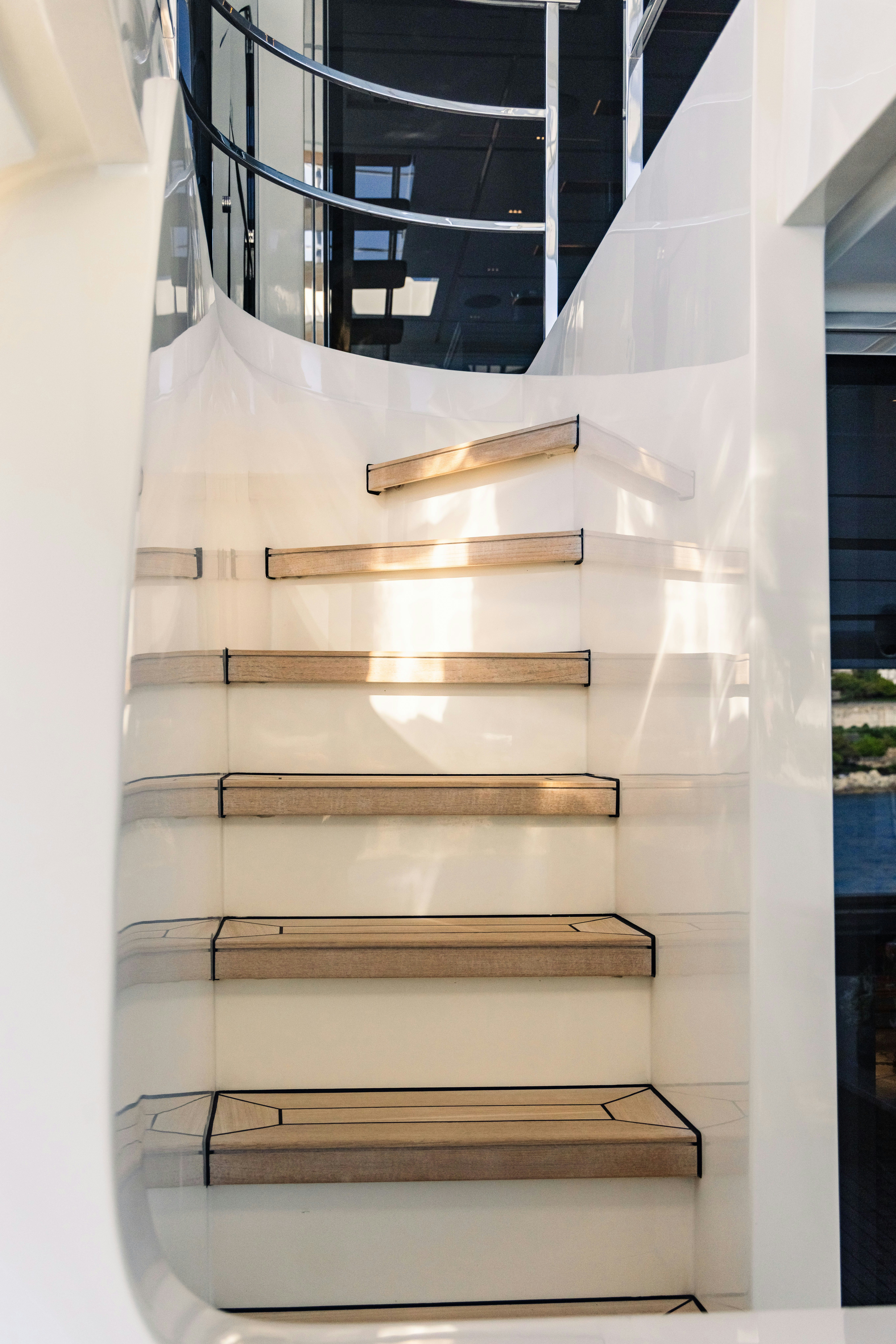 a white staircase with a wooden railing aboard PALOMA Yacht for Charter