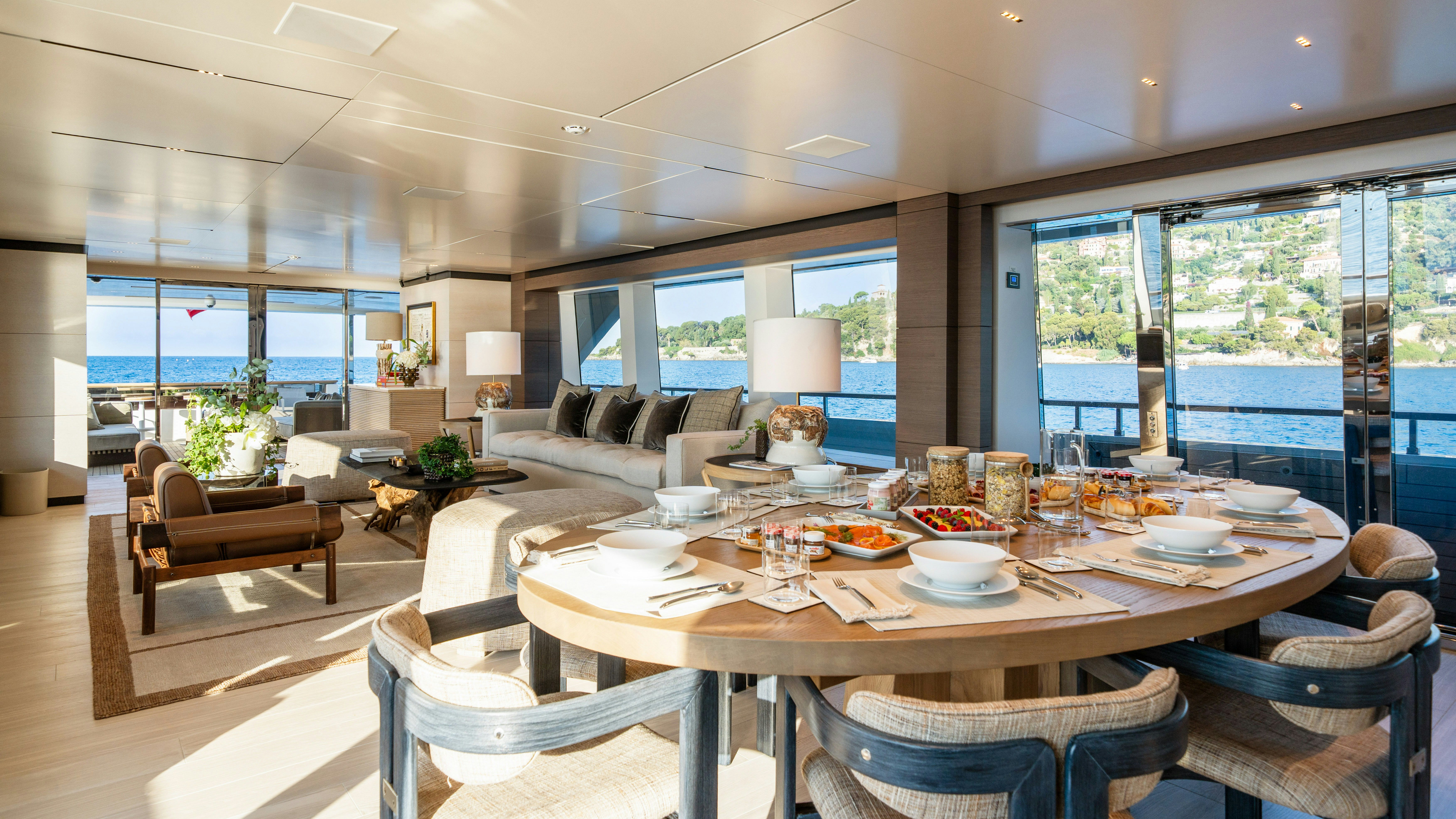 a large dining table in a living room aboard PALOMA Yacht for Charter