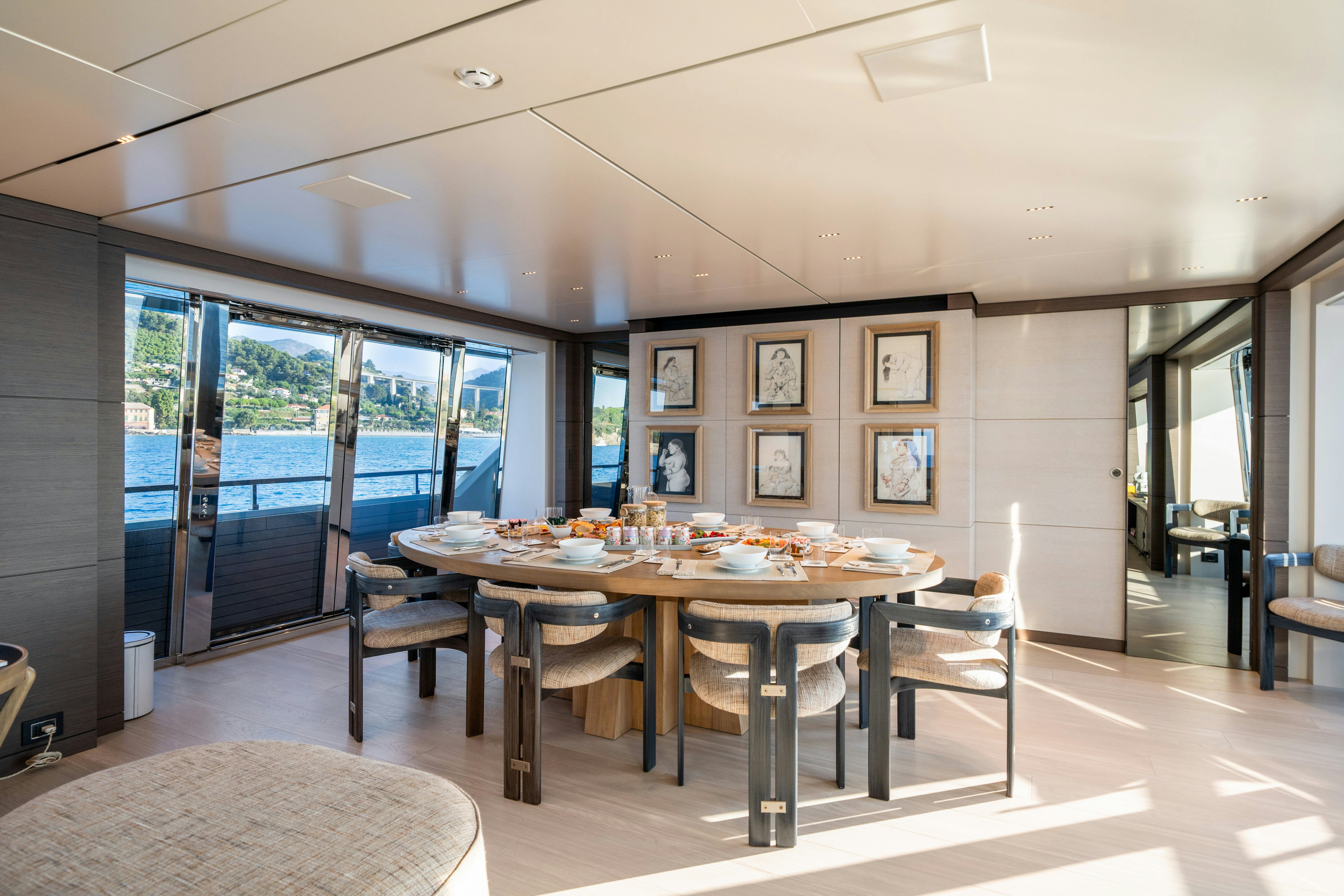 a large room with a table and chairs aboard PALOMA Yacht for Charter