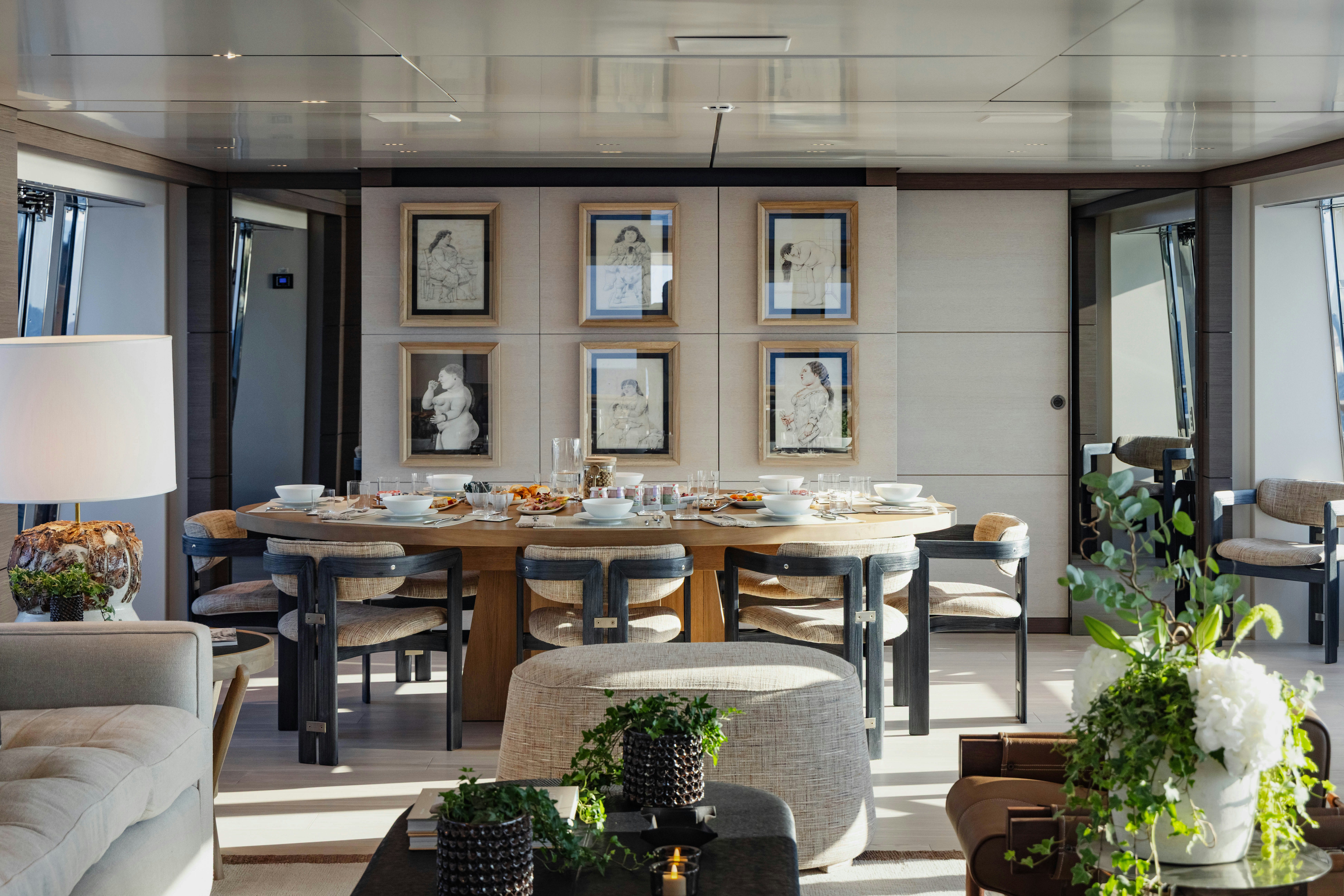 a room with tables and chairs aboard PALOMA Yacht for Charter