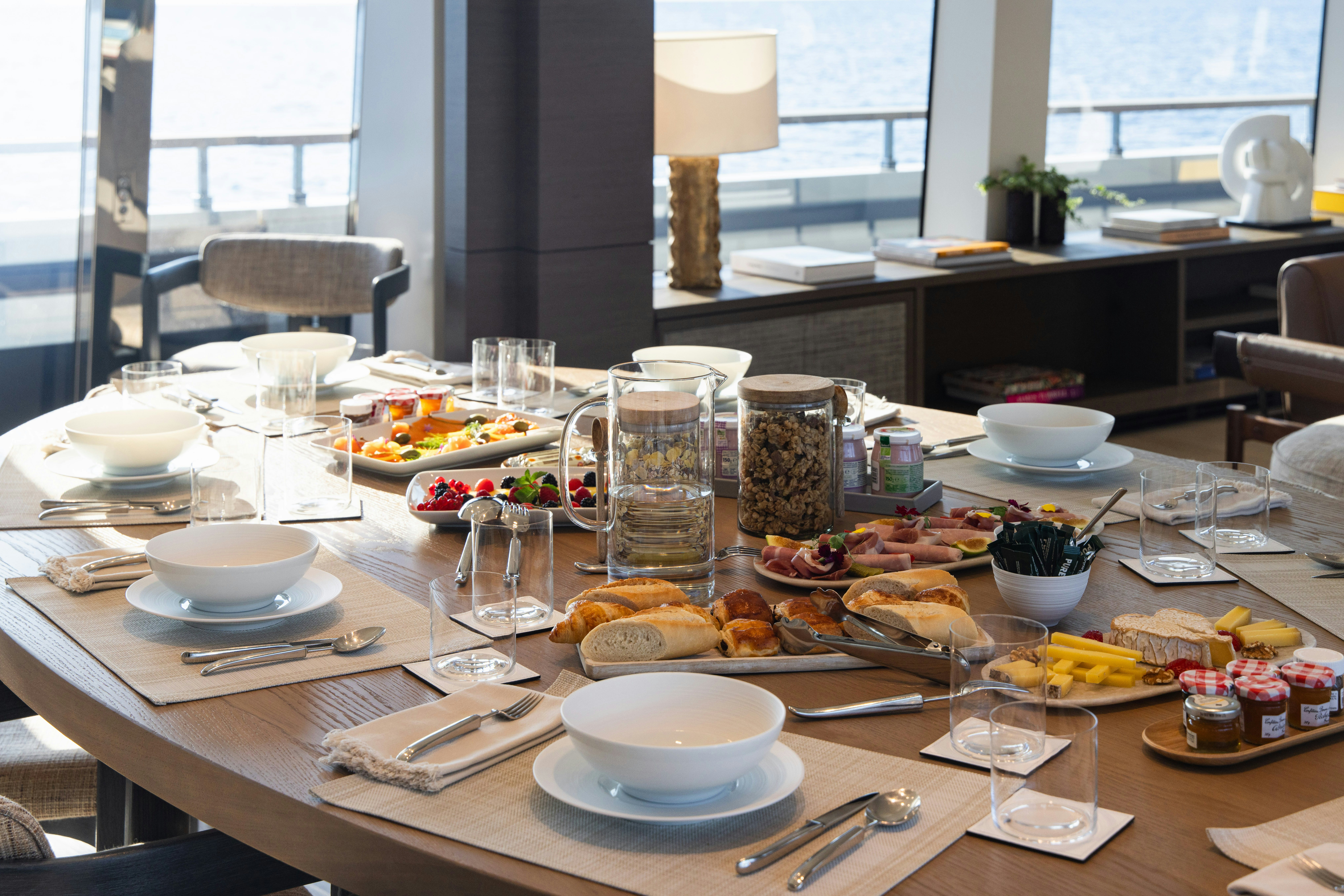 a table with plates and glasses aboard PALOMA Yacht for Charter