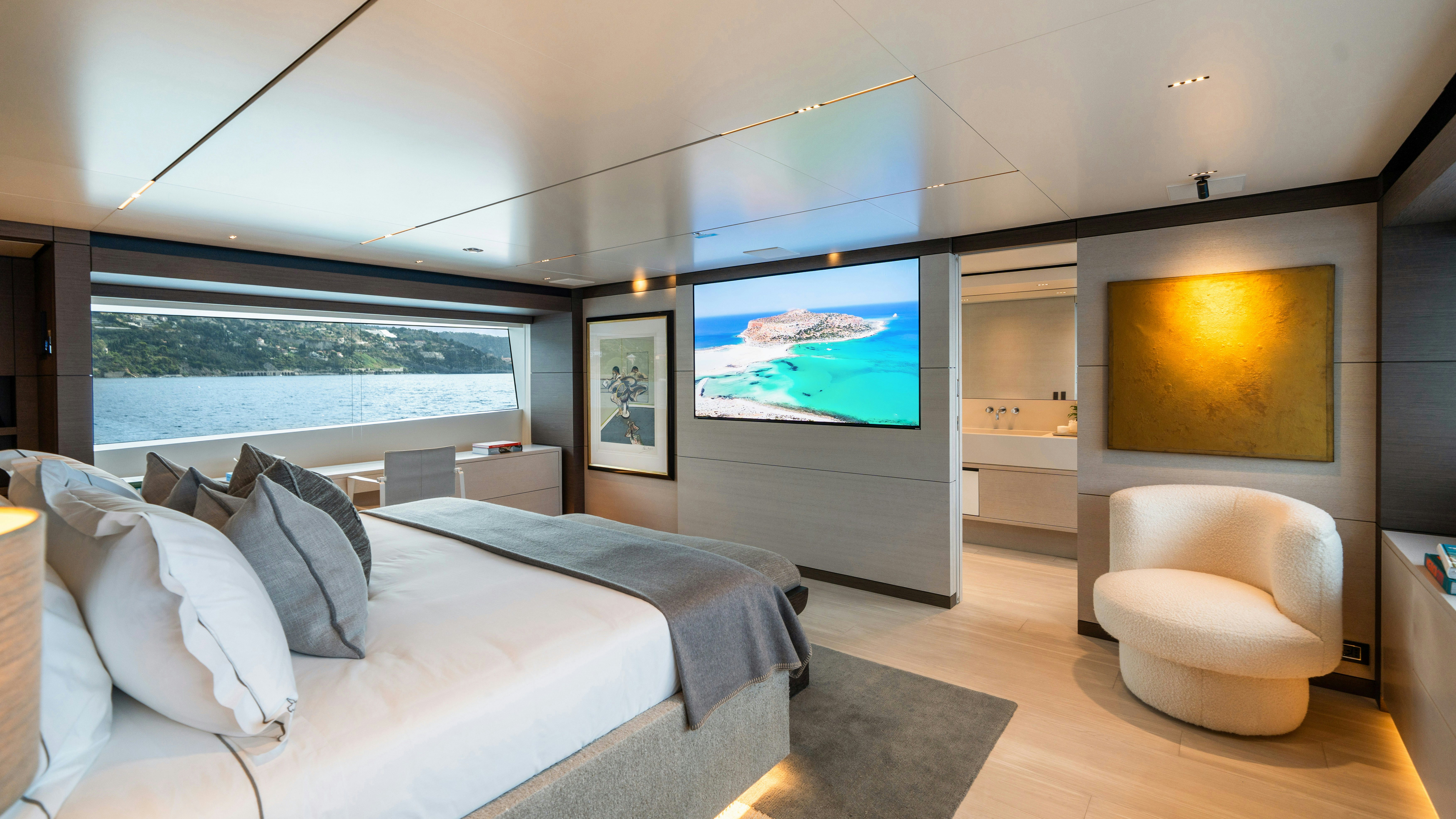 a bedroom with a large bed and a tv aboard PALOMA Yacht for Charter