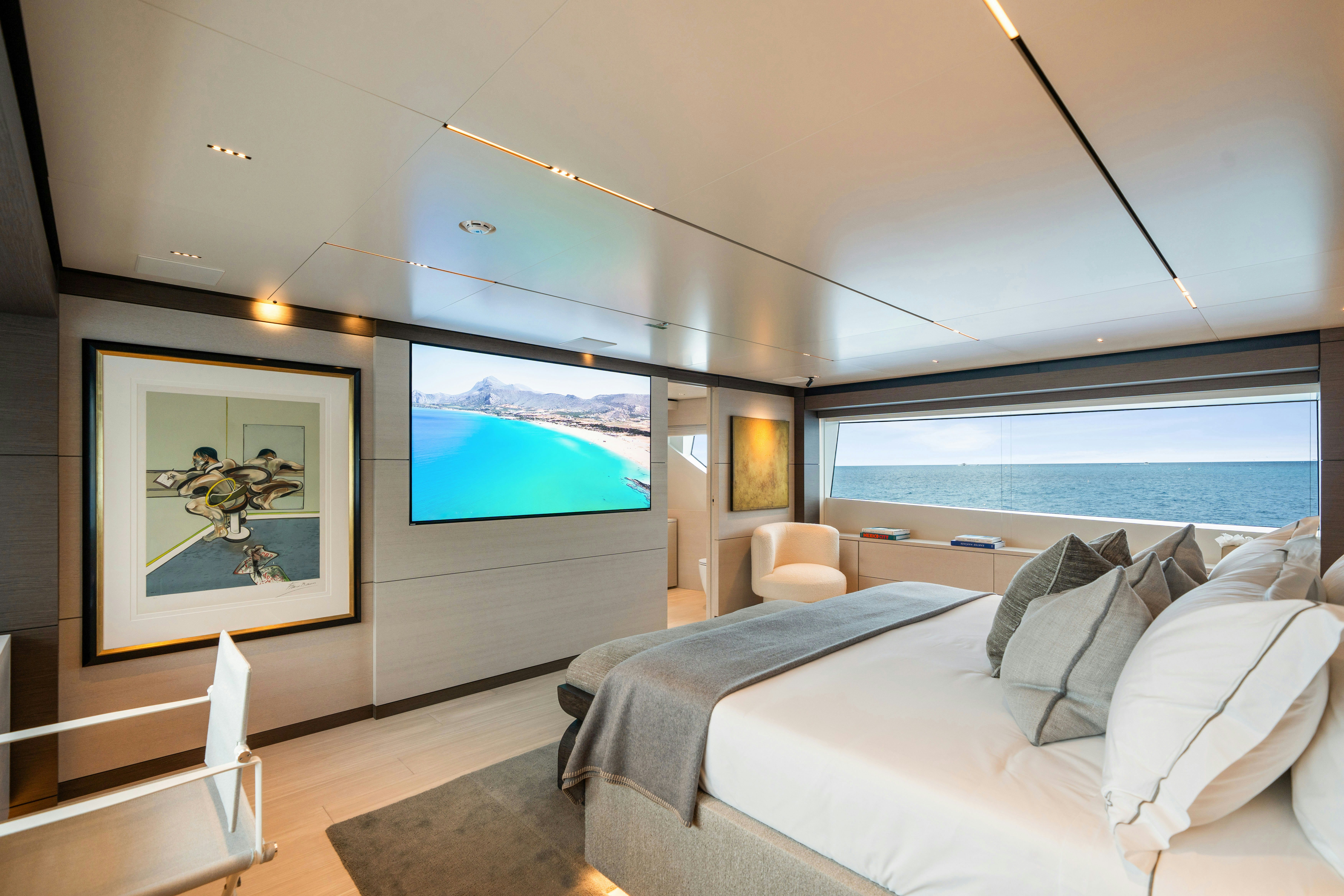 a room with a bed and a painting on the wall aboard PALOMA Yacht for Charter