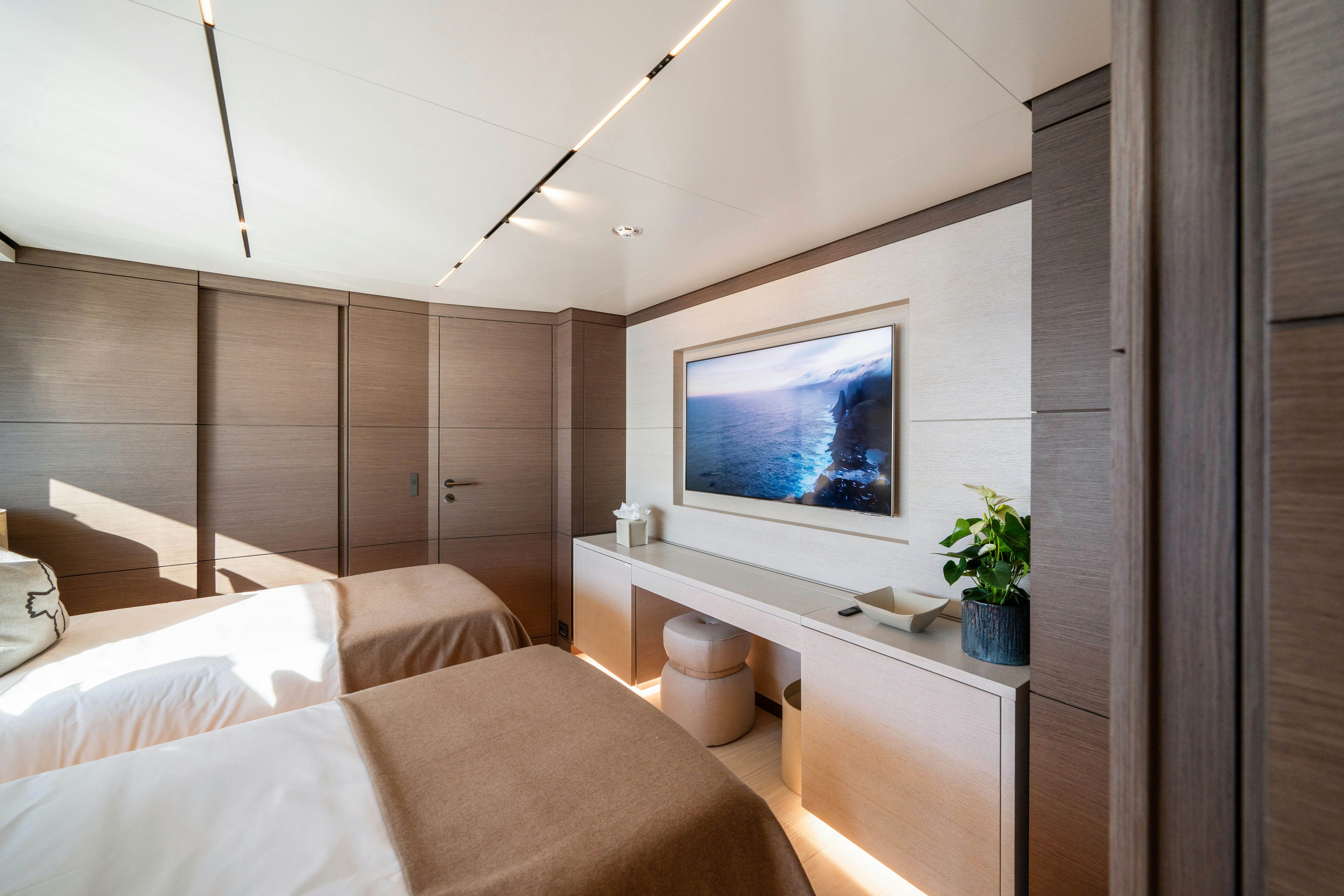 a room with a tv and furniture aboard PALOMA Yacht for Charter