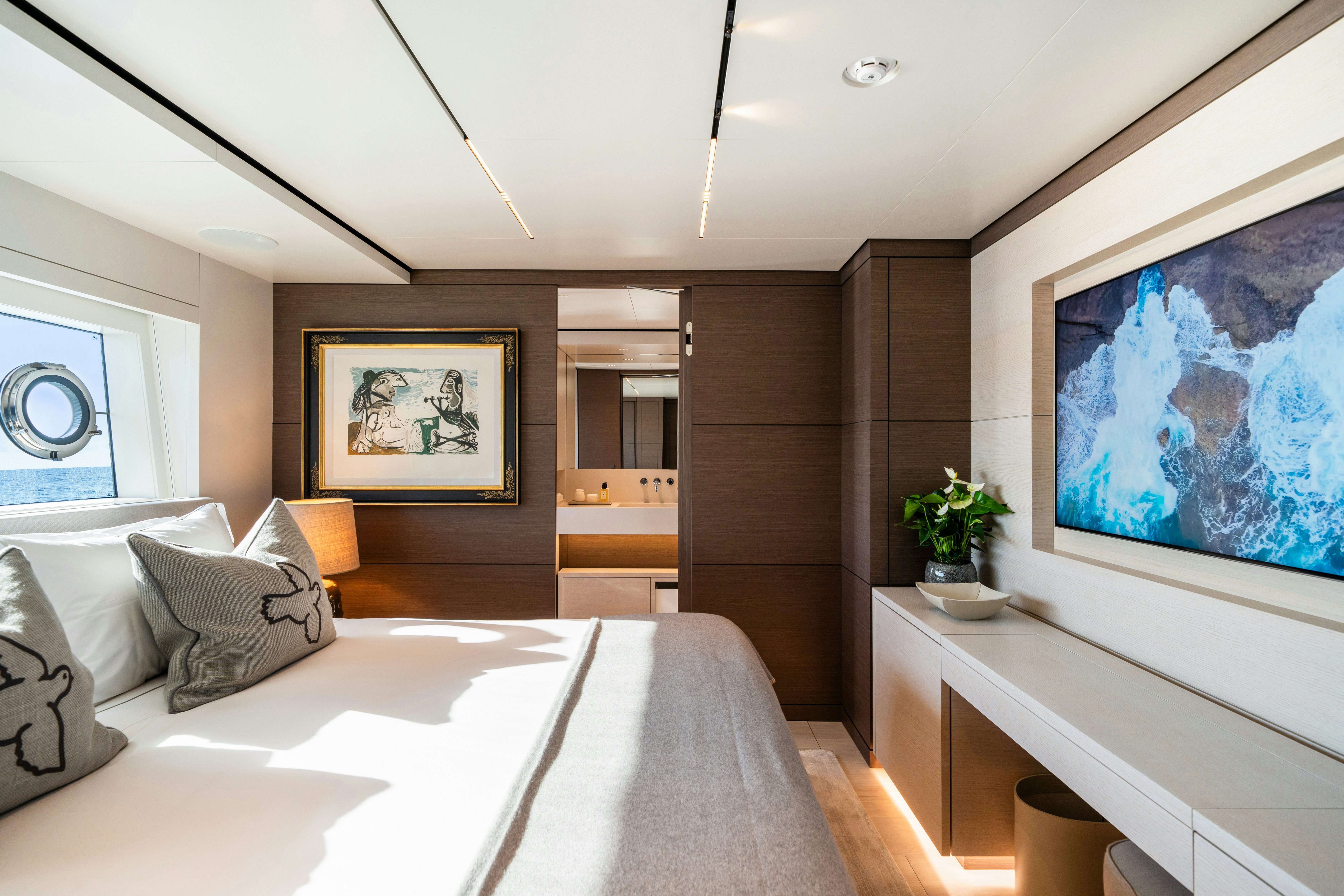a modern bedroom with a large bed aboard PALOMA Yacht for Charter