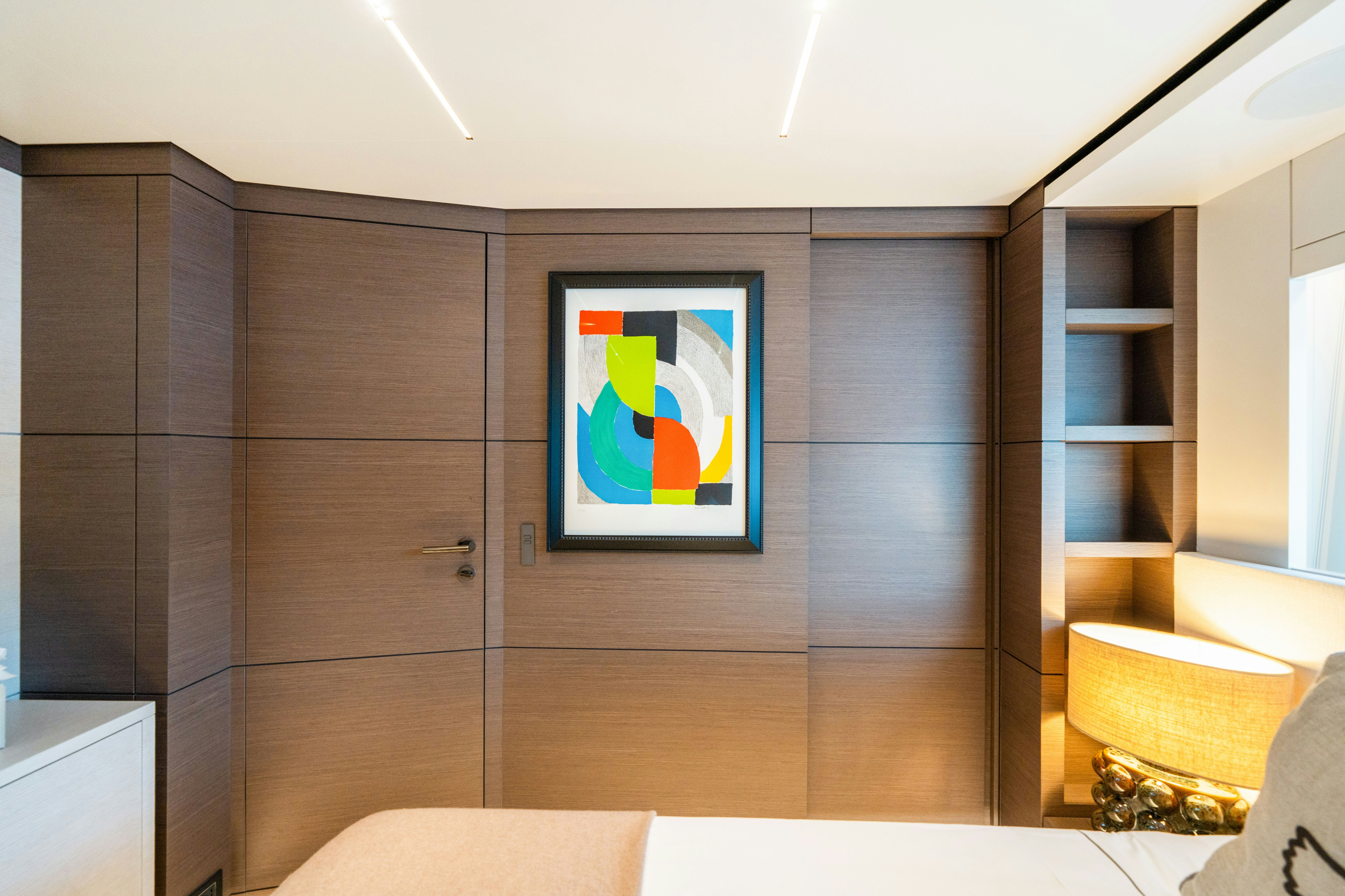 a room with a wood cabinet and a painting on the wall aboard PALOMA Yacht for Charter