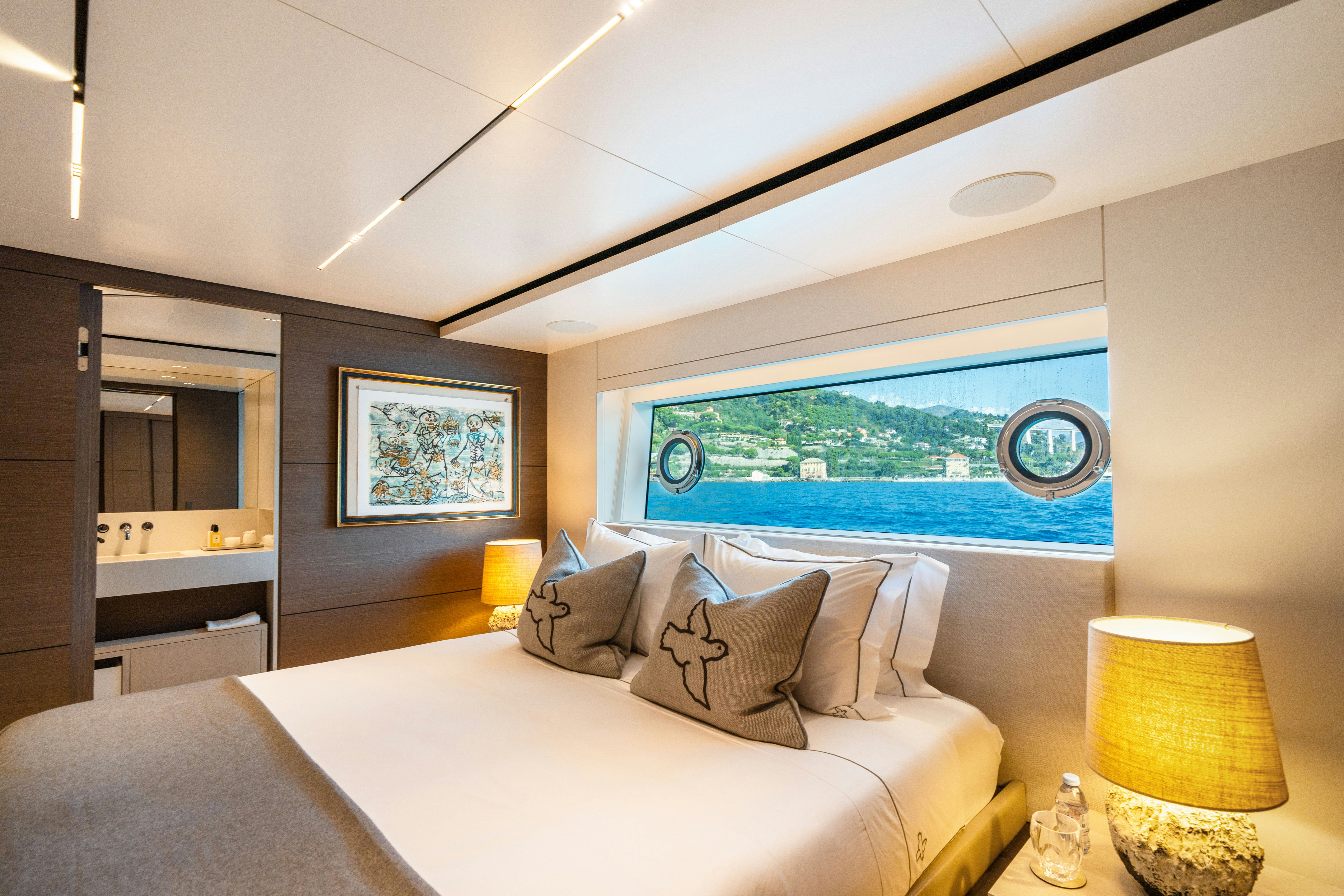 a bedroom with a large window aboard PALOMA Yacht for Charter
