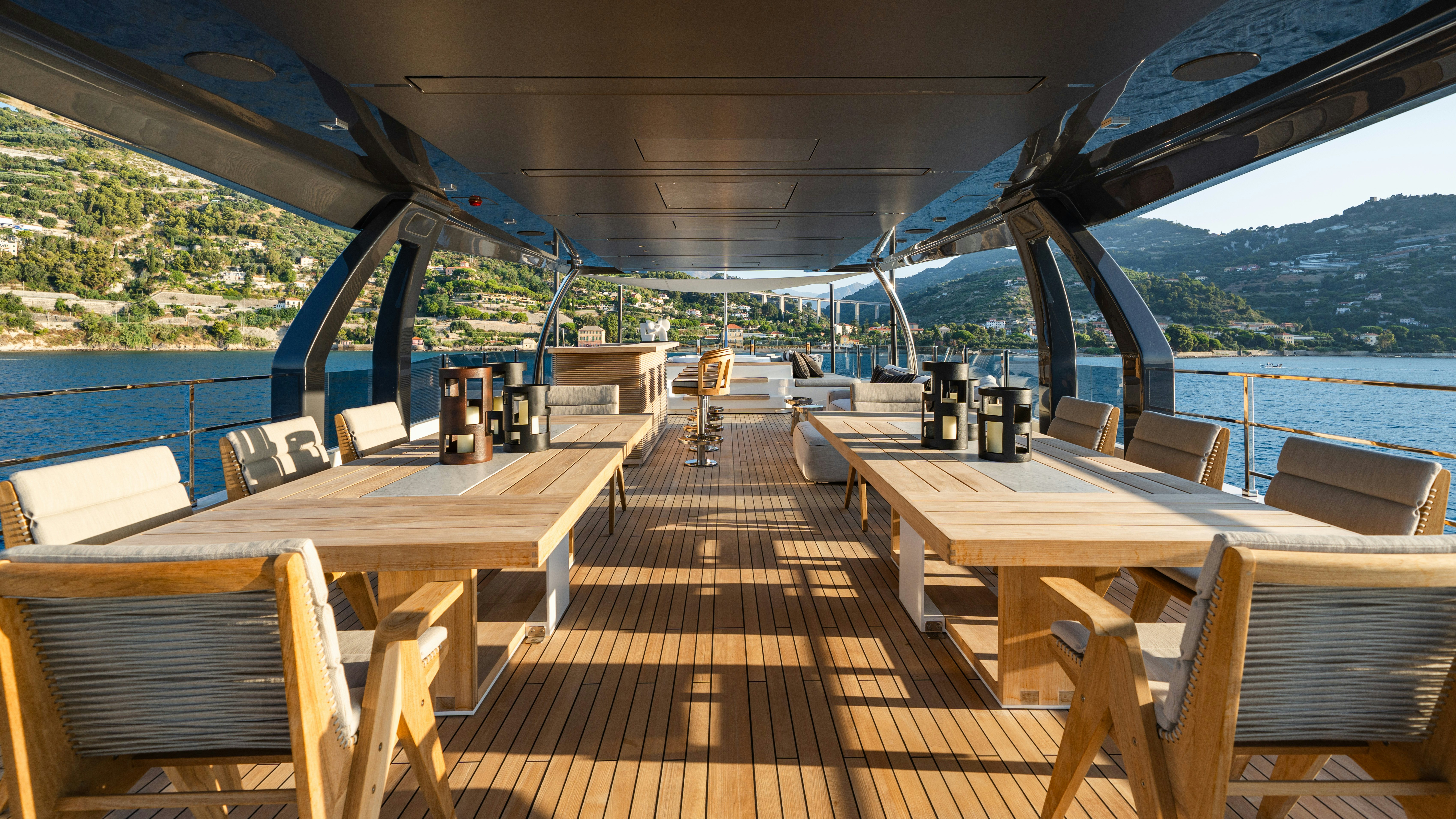 a deck with tables and chairs on it aboard PALOMA Yacht for Charter