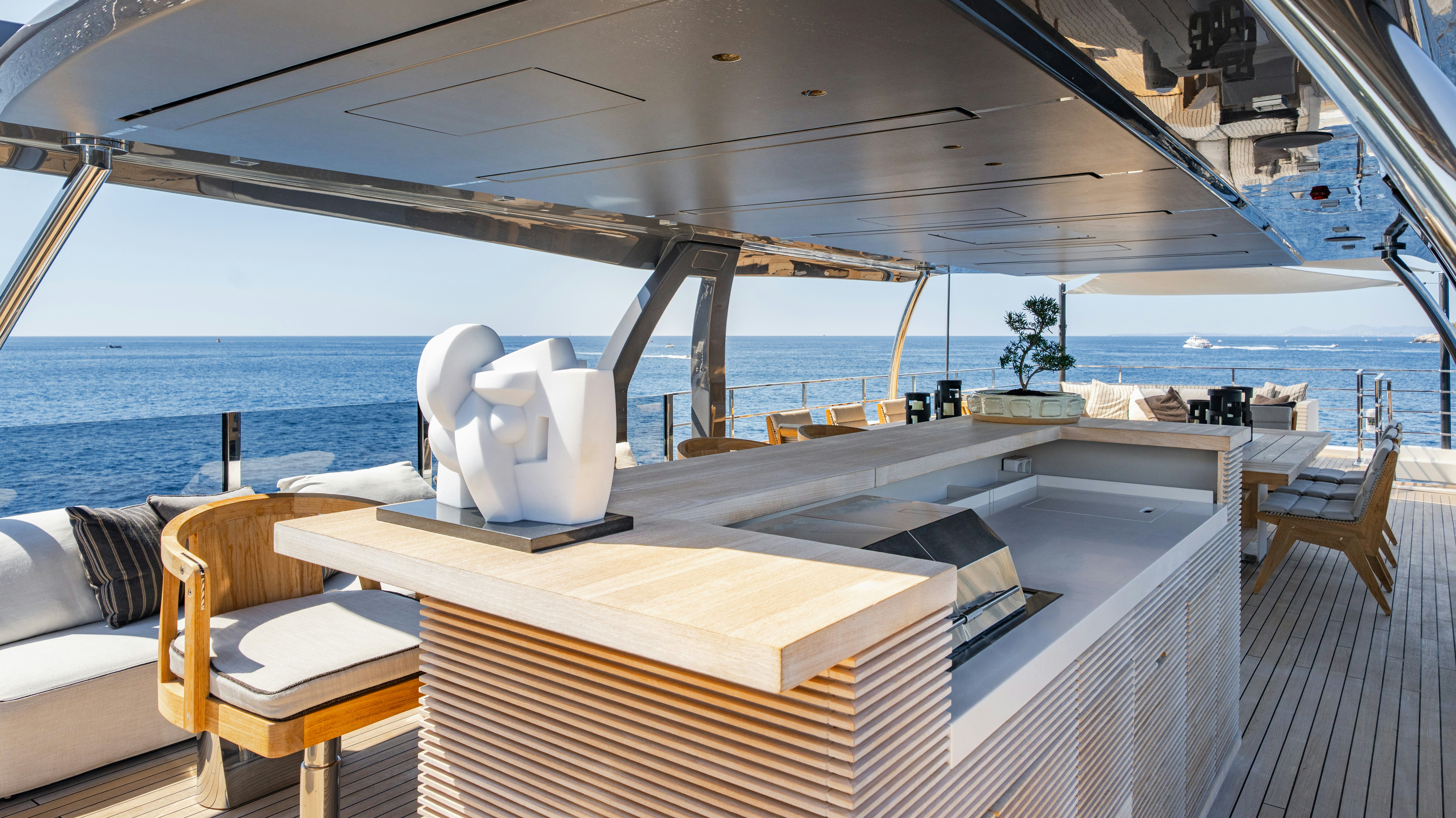 a large white lounge chair on a deck overlooking the ocean aboard PALOMA Yacht for Charter