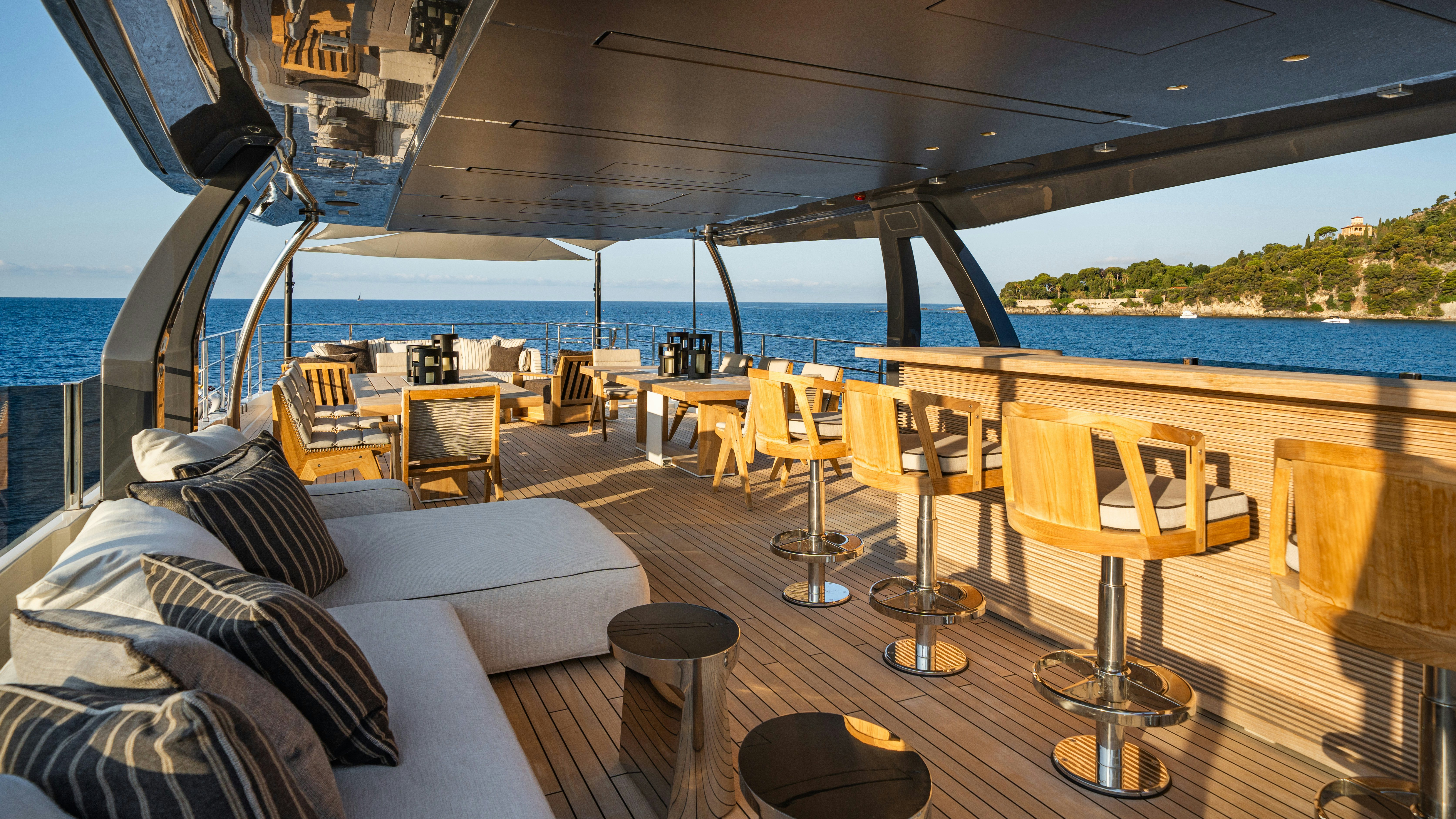 a boat with a bed and chairs aboard PALOMA Yacht for Charter