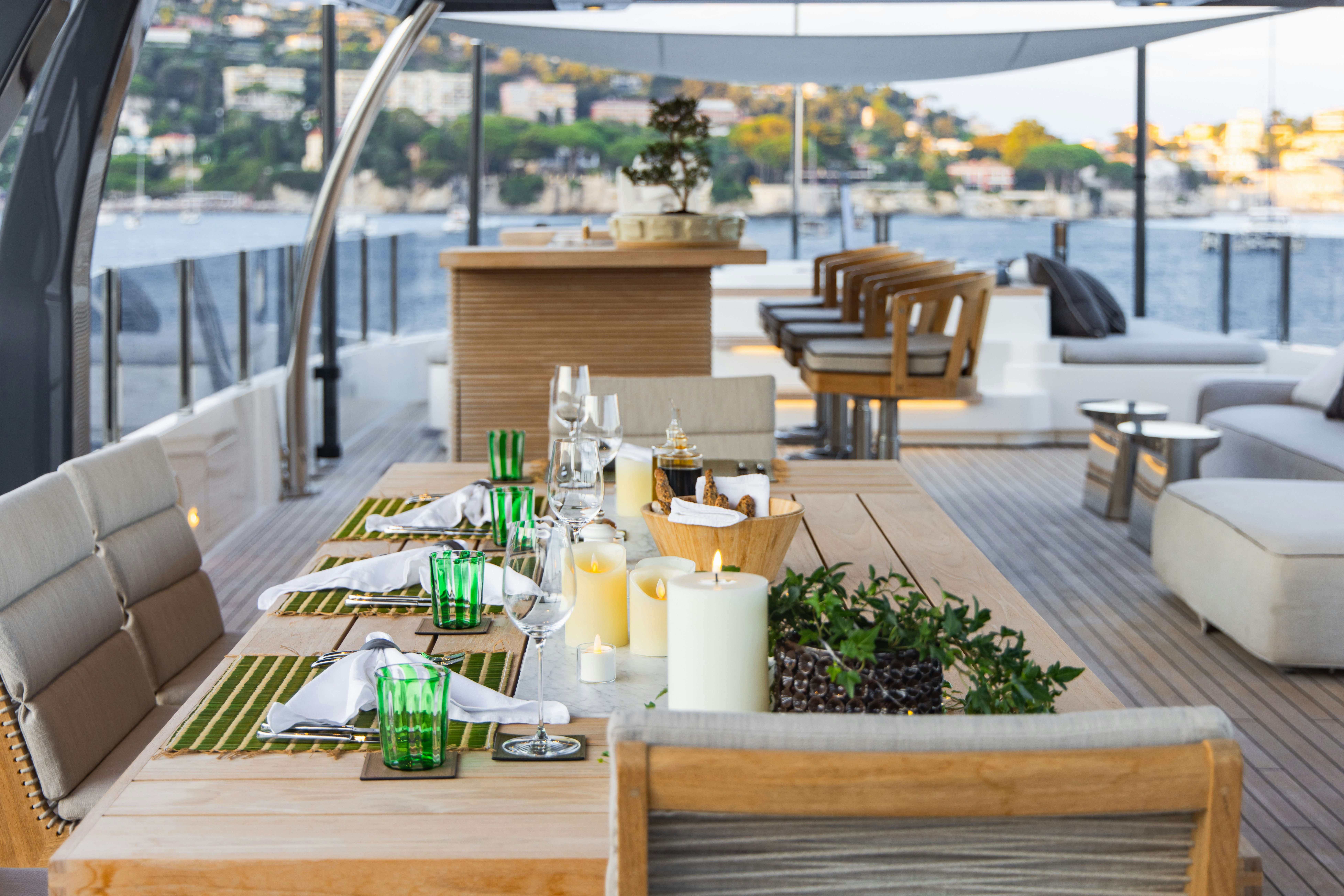 a table with chairs and a plant on it aboard PALOMA Yacht for Charter
